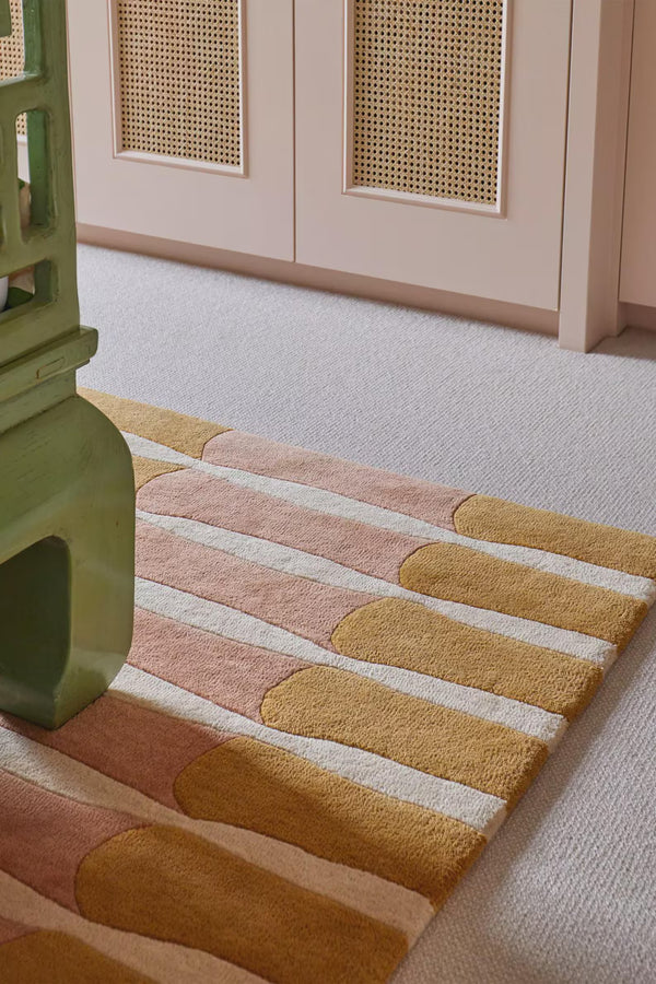 Amberline Rug placed in a bright hallway, showcasing its striped design and soft tones that enhance narrow spaces with warmth and style.