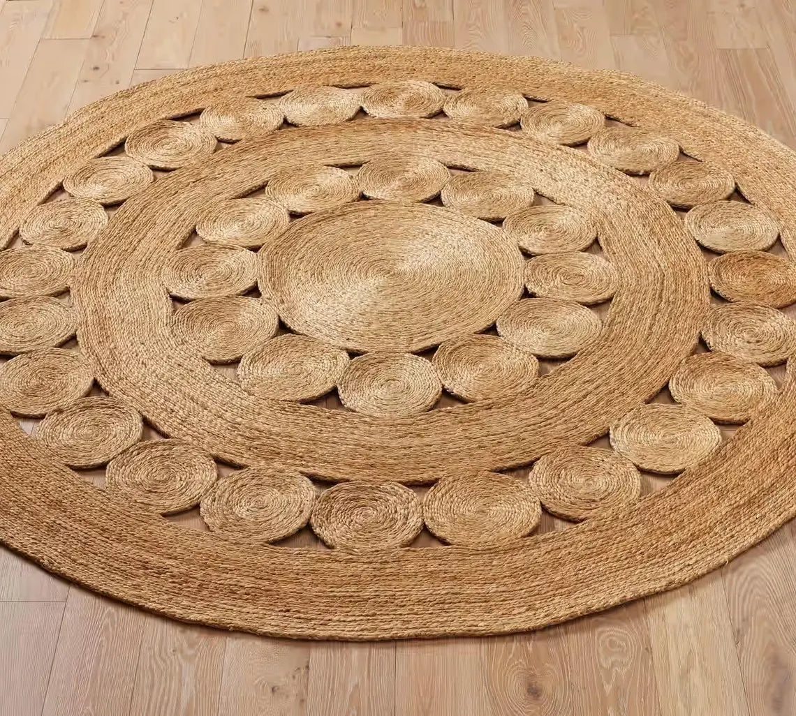 Round Bask Jute Rug placed on a wooden floor, showcasing its layered circular weave and natural golden texture that adds warmth to contemporary interiors.