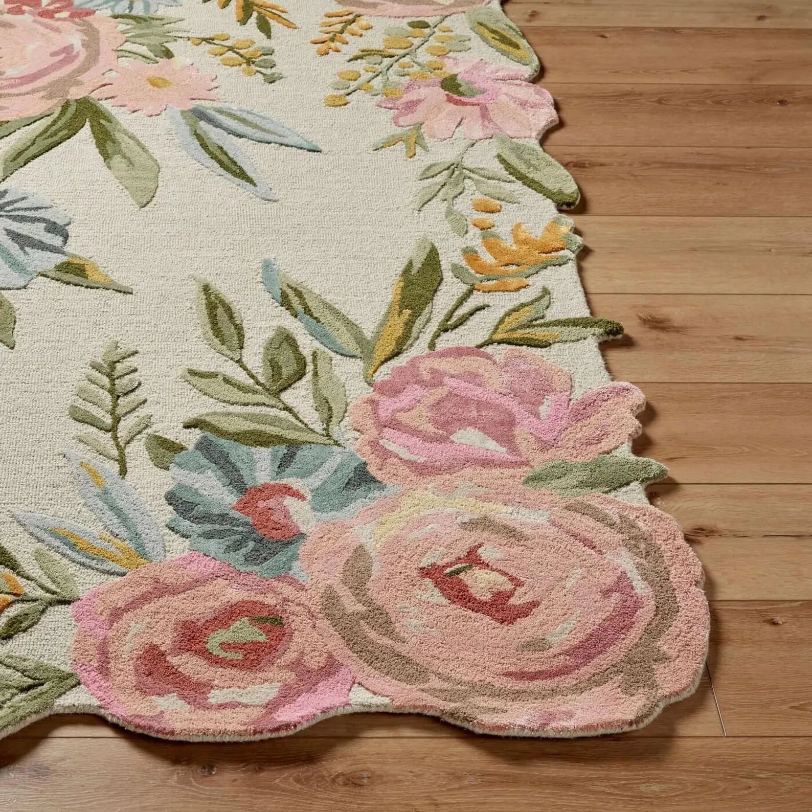 Blooming Meadow hand tufted rug showing detailed floral patterns and textured tufting on a wooden