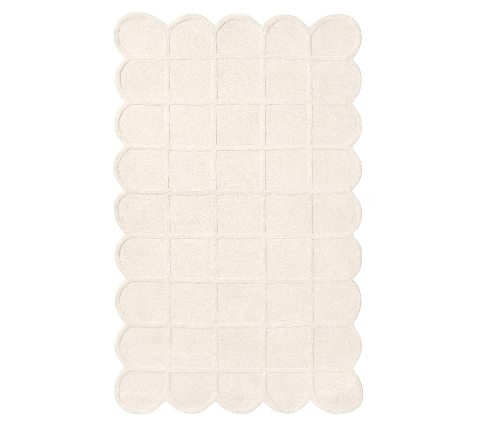 Top-view of Blush Quilt Rug in cream color featuring scalloped edges and quilted square detailing on a clean white background, highlighting its handcrafted texture and soft plush surface.