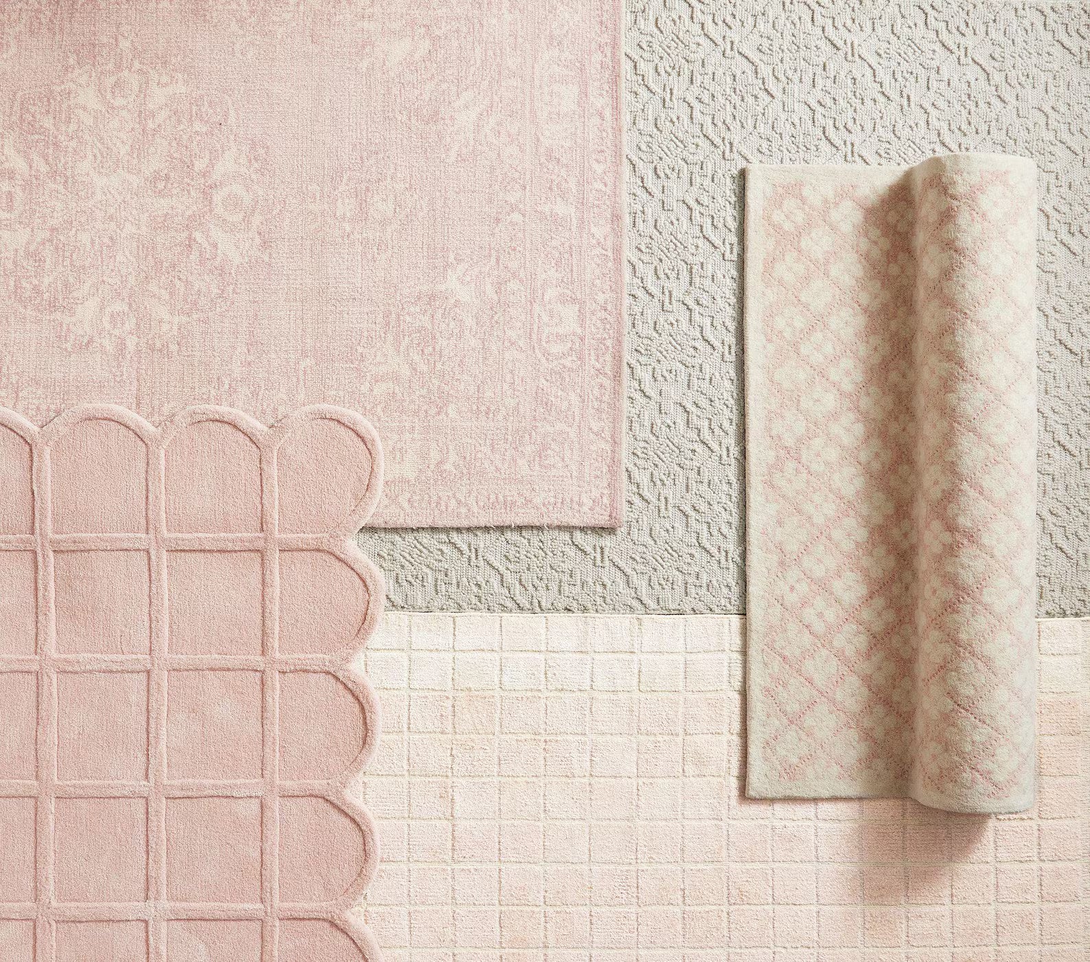 Flatlay composition featuring the Blush Quilt Rug with scalloped edges alongside coordinating pastel rugs, showcasing soft pink textures and woven surface contrast.