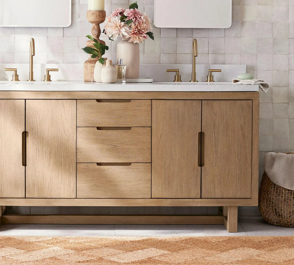 Cascara Rug styled beneath a wooden vanity with brass fixtures, adding natural texture and warmth to a modern bathroom interior.