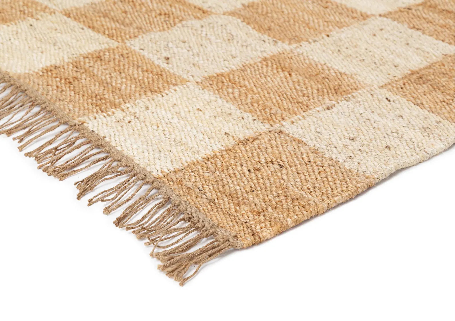 Chesson Rug flat weave close-up showing natural jute texture, beige and ivory checker pattern, and fringed edges.