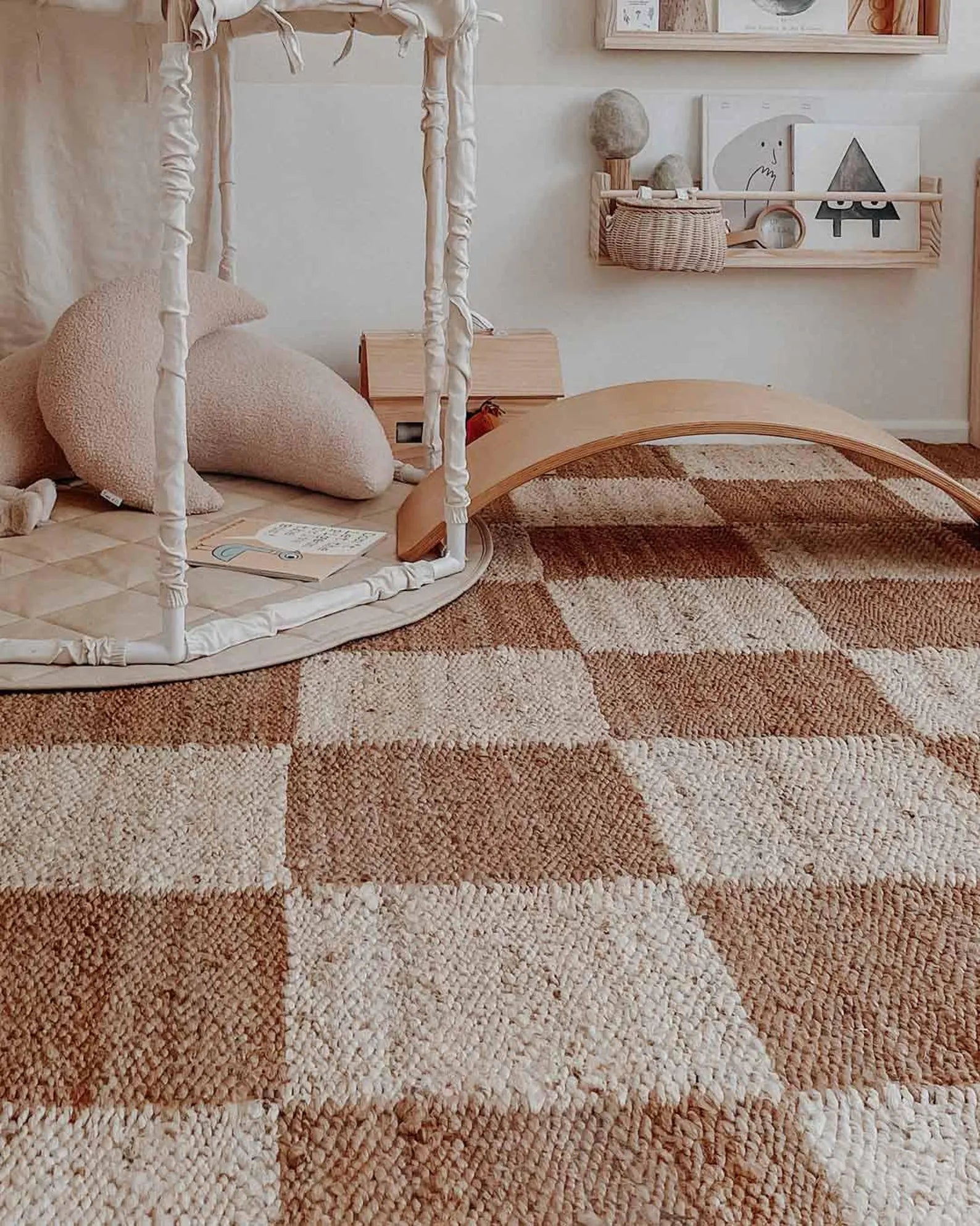 Chesson Rug styled in a minimal nursery space with soft toys and wooden decor, highlighting its natural jute checker pattern in beige and brown tones.