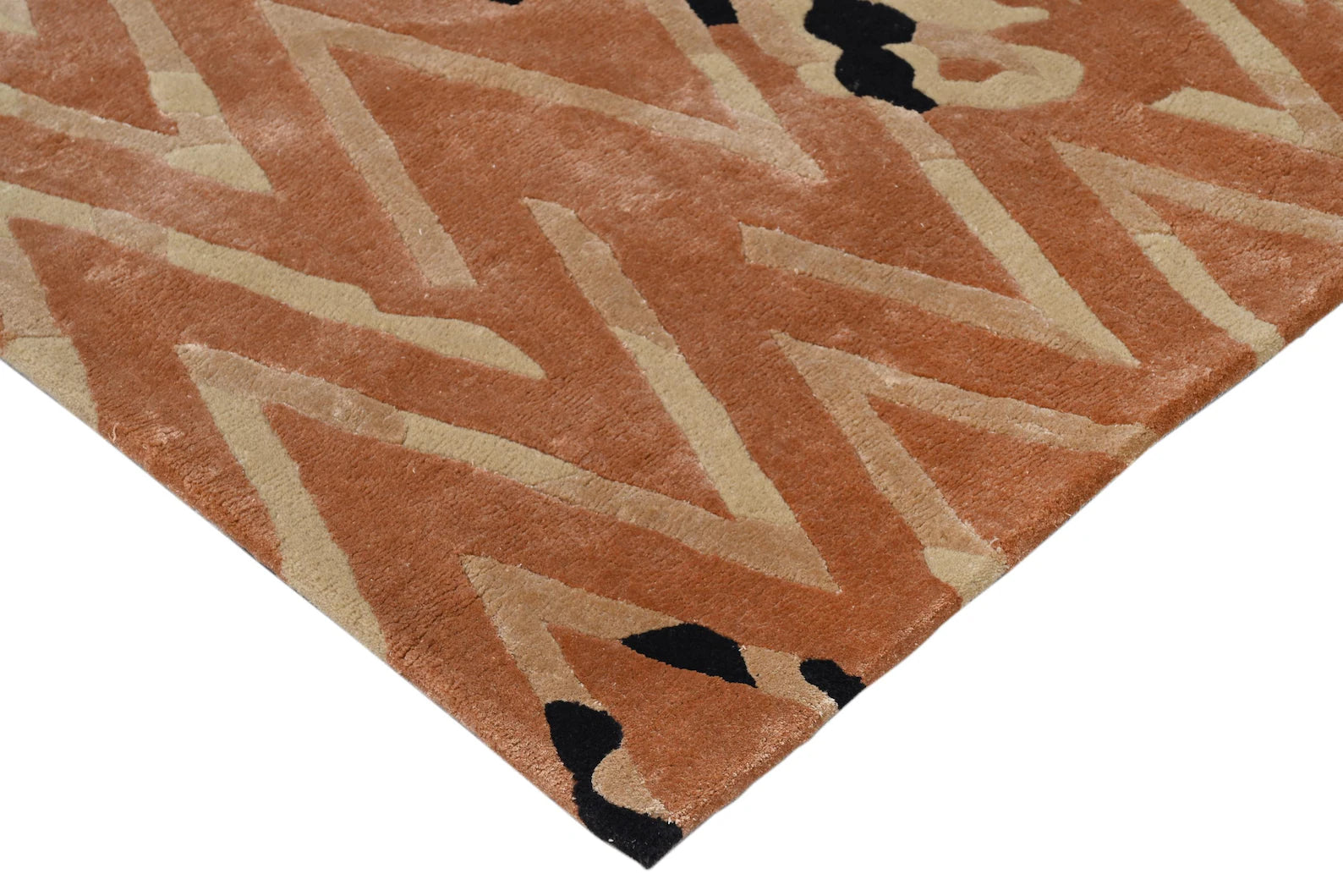 Corner shot of Chevron Distorted Rug displaying clean edges, black geometric motifs, and vibrant hand-tufted surface.