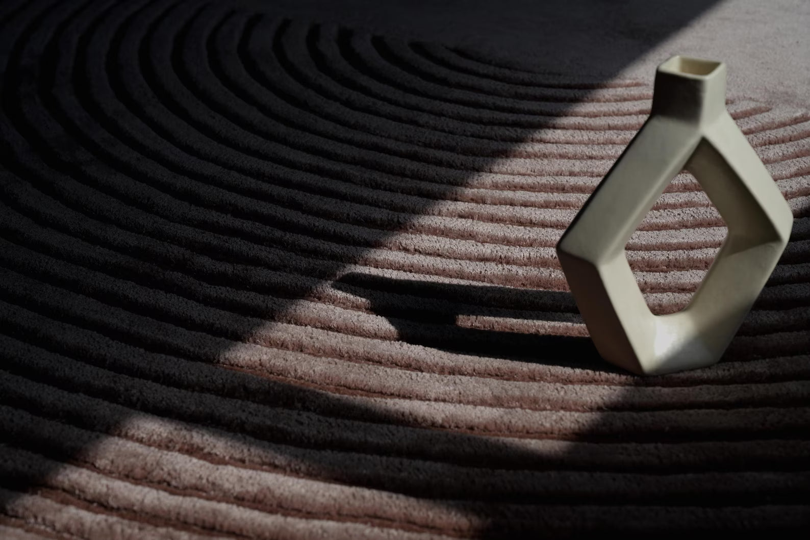 Contemporary circular rug with concentric lines for modern home styling.