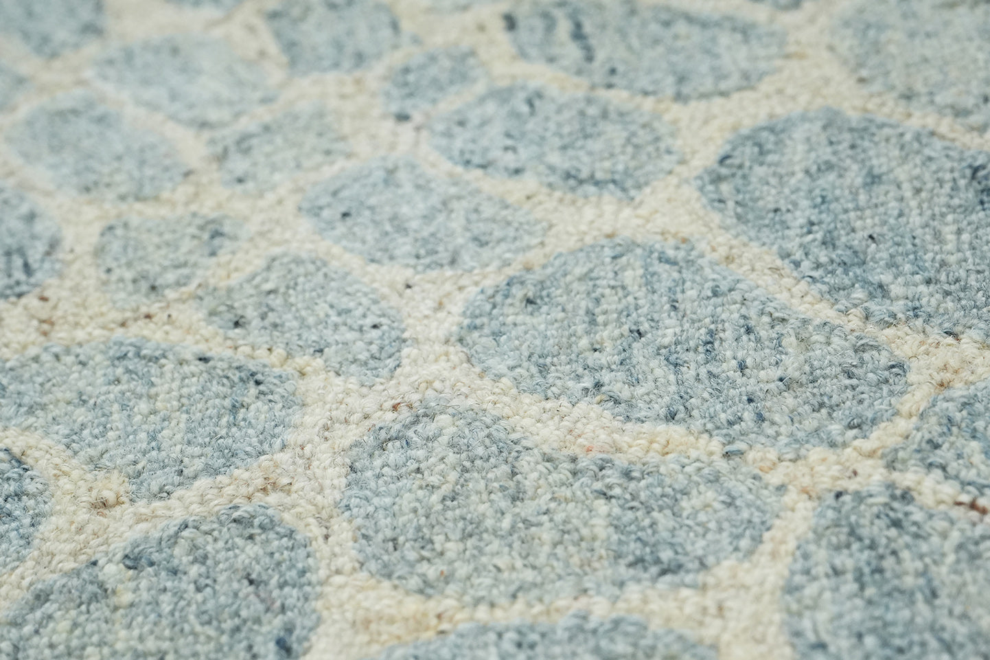 Close up of hand tufted Coastal Stone Pattern Rug highlighting stone inspired pattern and wool surface texture