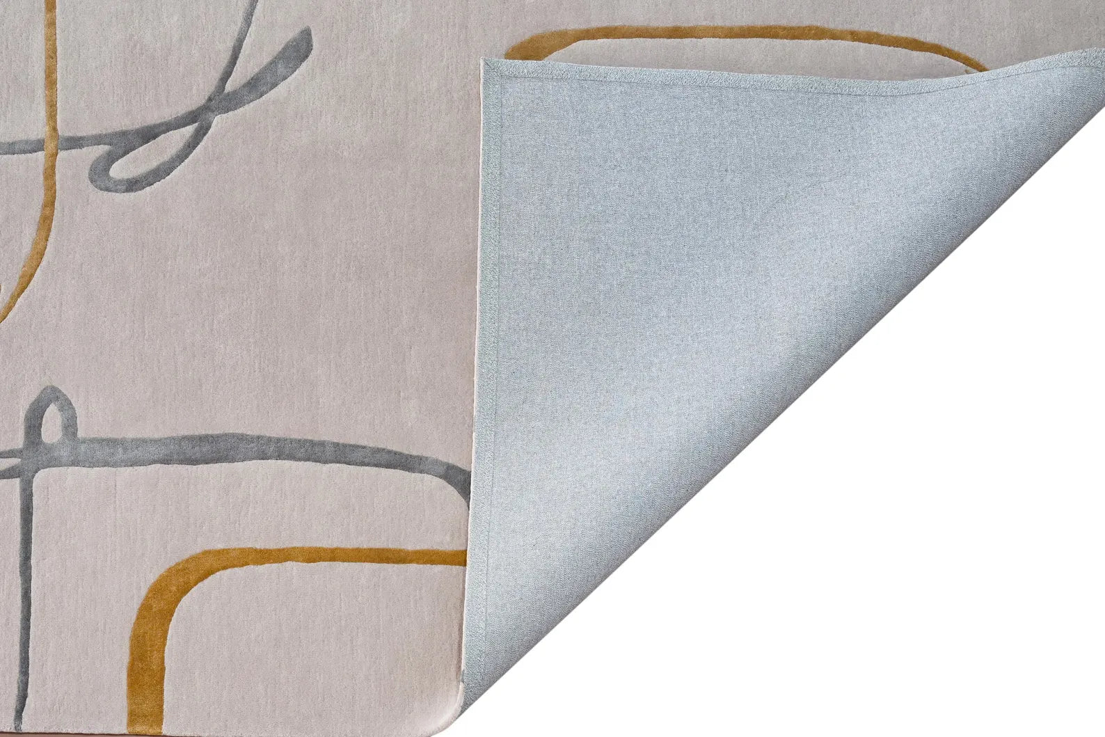 Contour Thread Rug corner fold showing layered surface, fine hand tufted detailing, and abstract linear design in beige, grey, and mustard tones