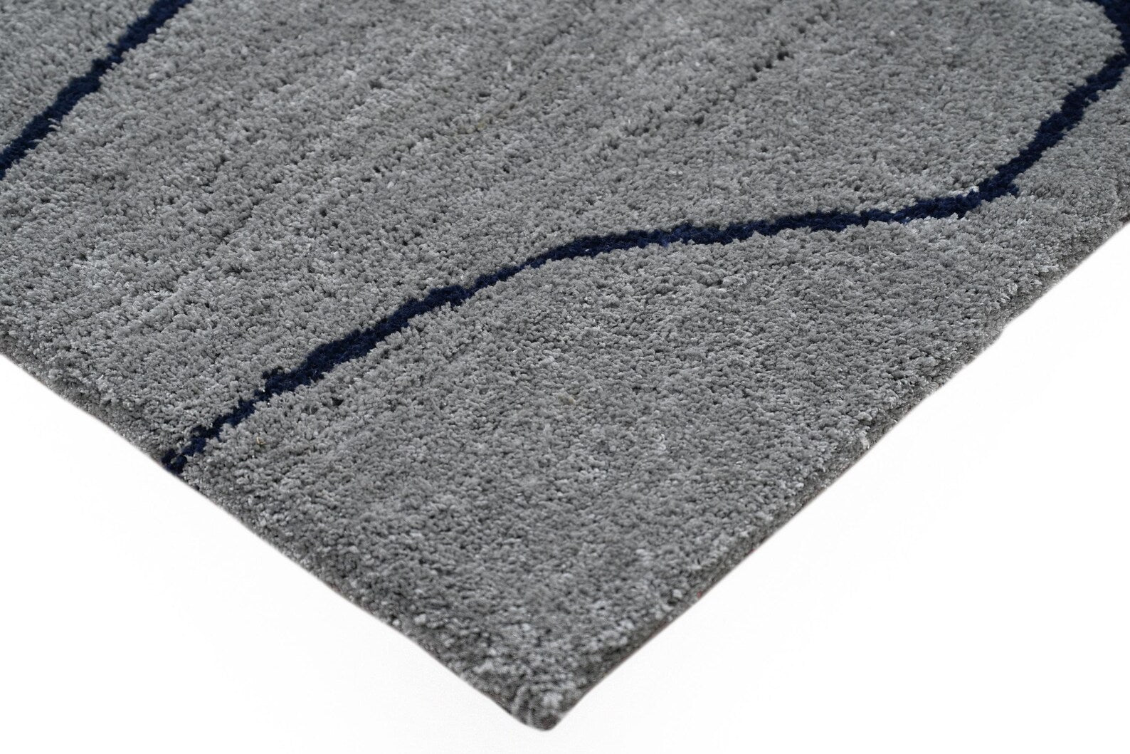 Corner detail studio view of Abstract Line Art Grey Rug showing soft grey base with dark abstract line pattern on a clean white background