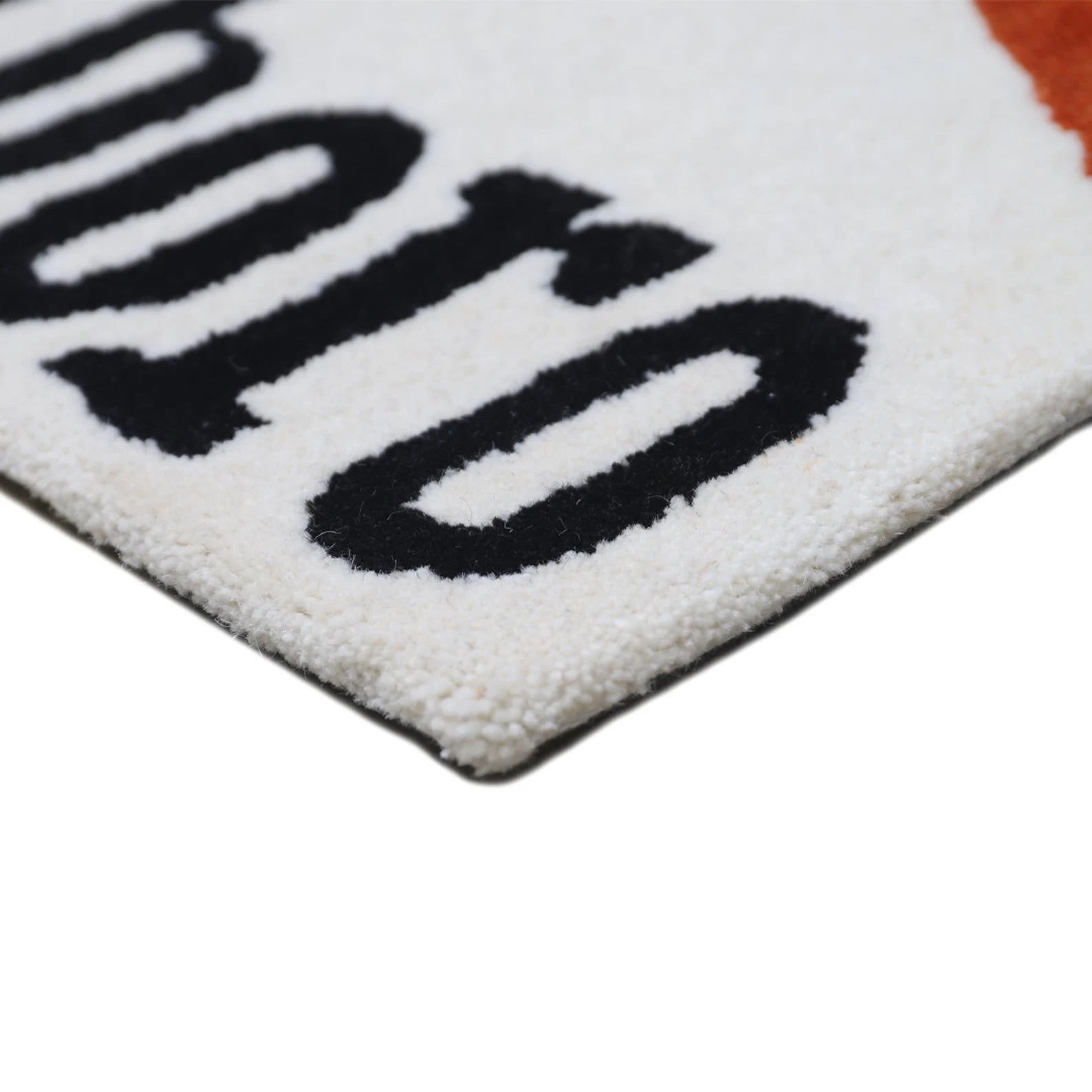 Corner detail view of Marlboro Doormat showing clean edge finishing and thick hand tufted pile texture