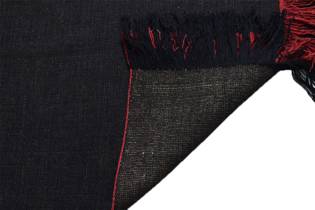 Corner fold view of Auskin Luxury Black Rug showing underside texture and handcrafted weave pattern