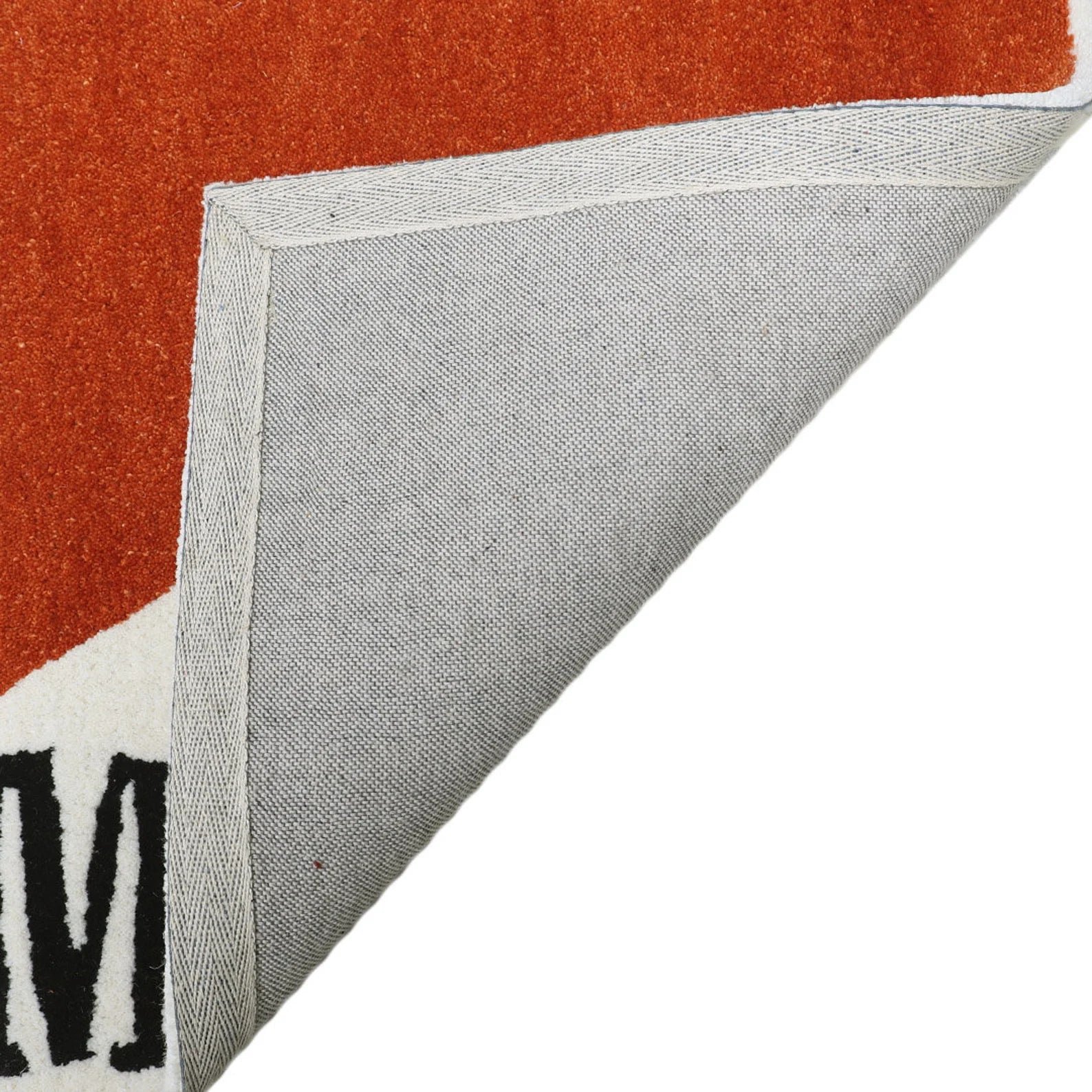 Corner fold view of Marlboro Doormat highlighting grey non-slip backing and durable layered construction