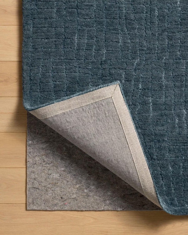 Blue textured rug on a wooden floor