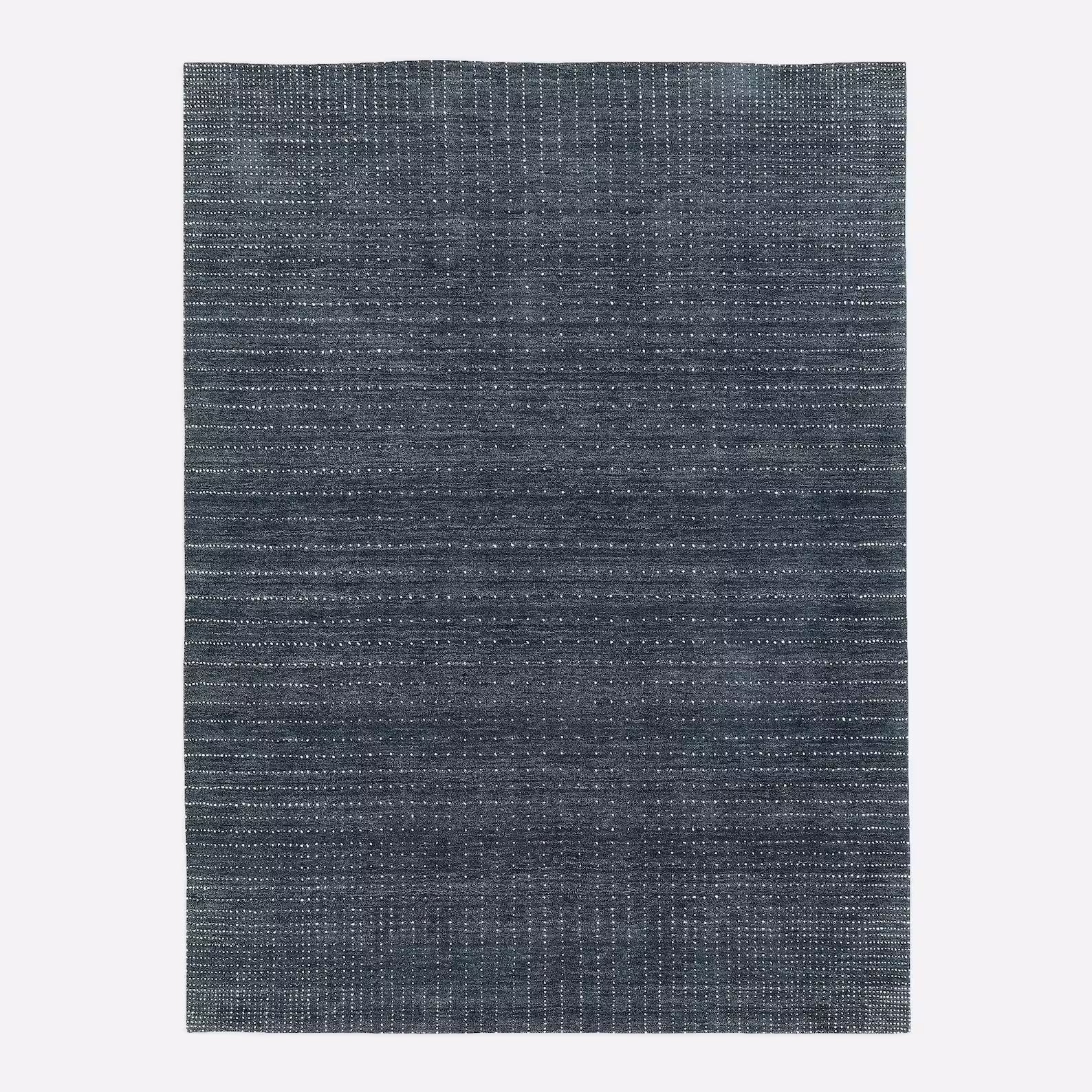 Overhead view of the Driftstone Rug displaying its uniform handwoven texture and deep slate tone, highlighting its modern, minimalist design appeal.