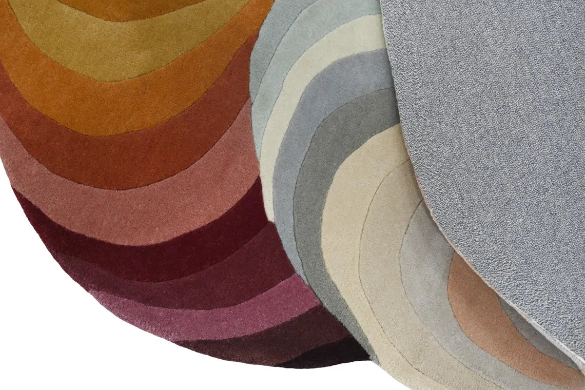 Hand tufted rug with bold trellis design in multiple shades.