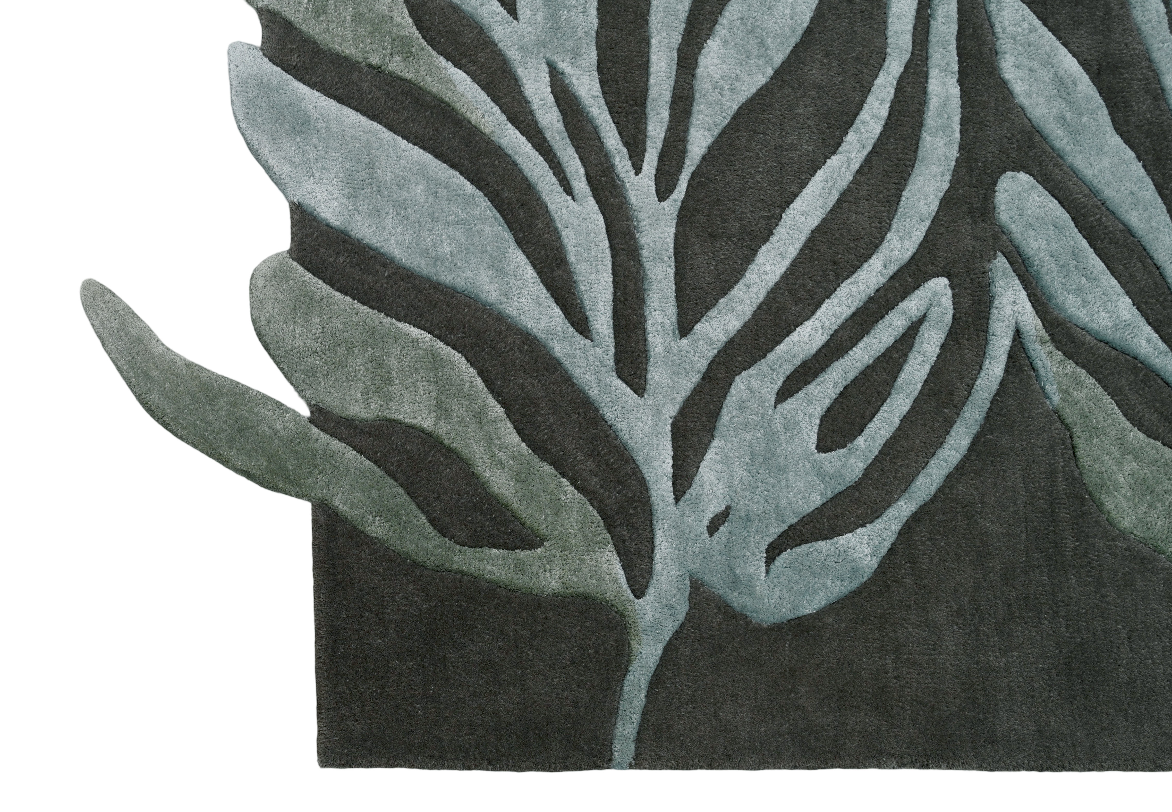 Close-up of Falling Leaves Rug showing detailed leaf patterns in green tones.