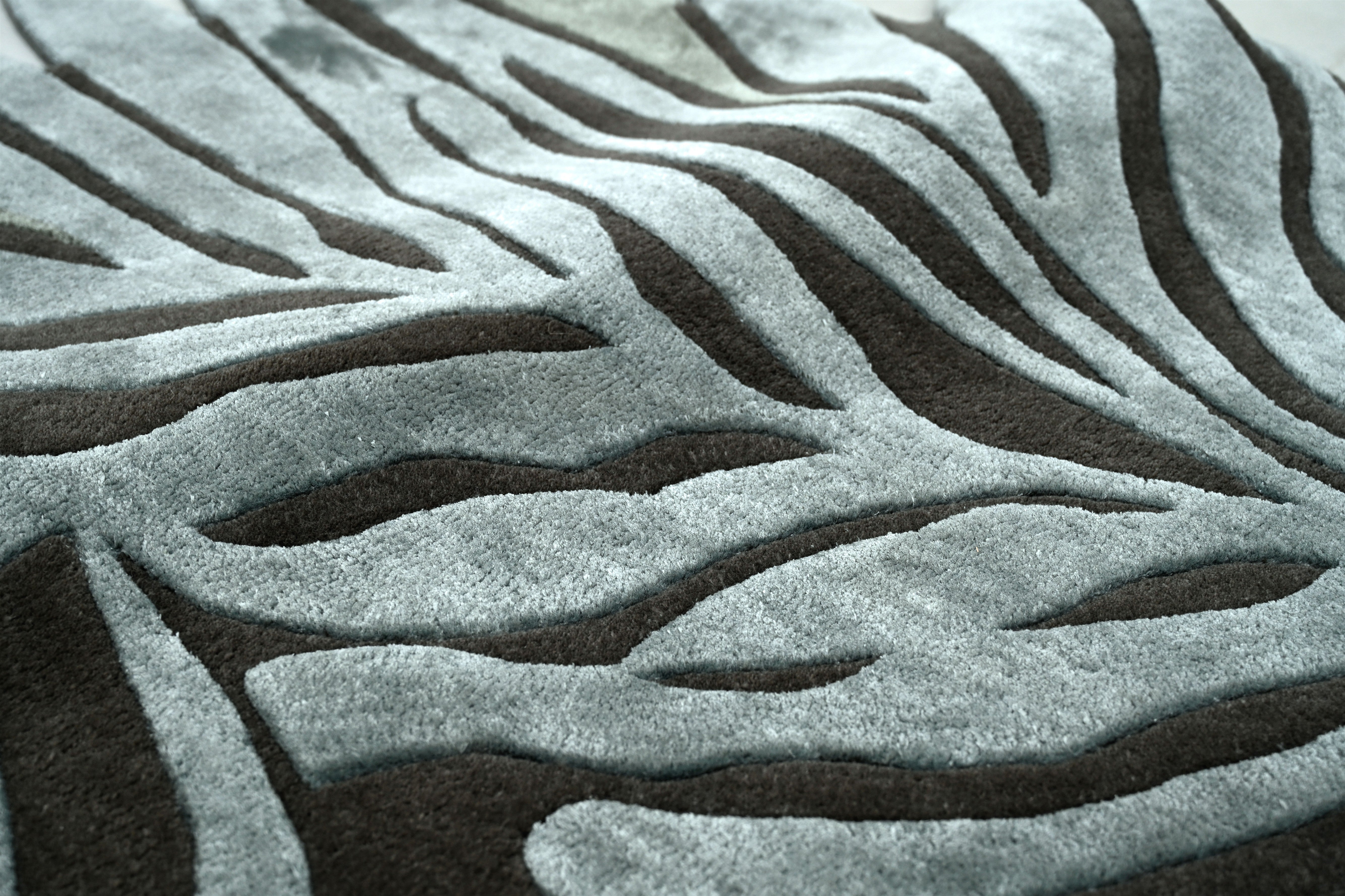 Zoomed-in look at the carved leaf patterns of the Falling Leaves Rug