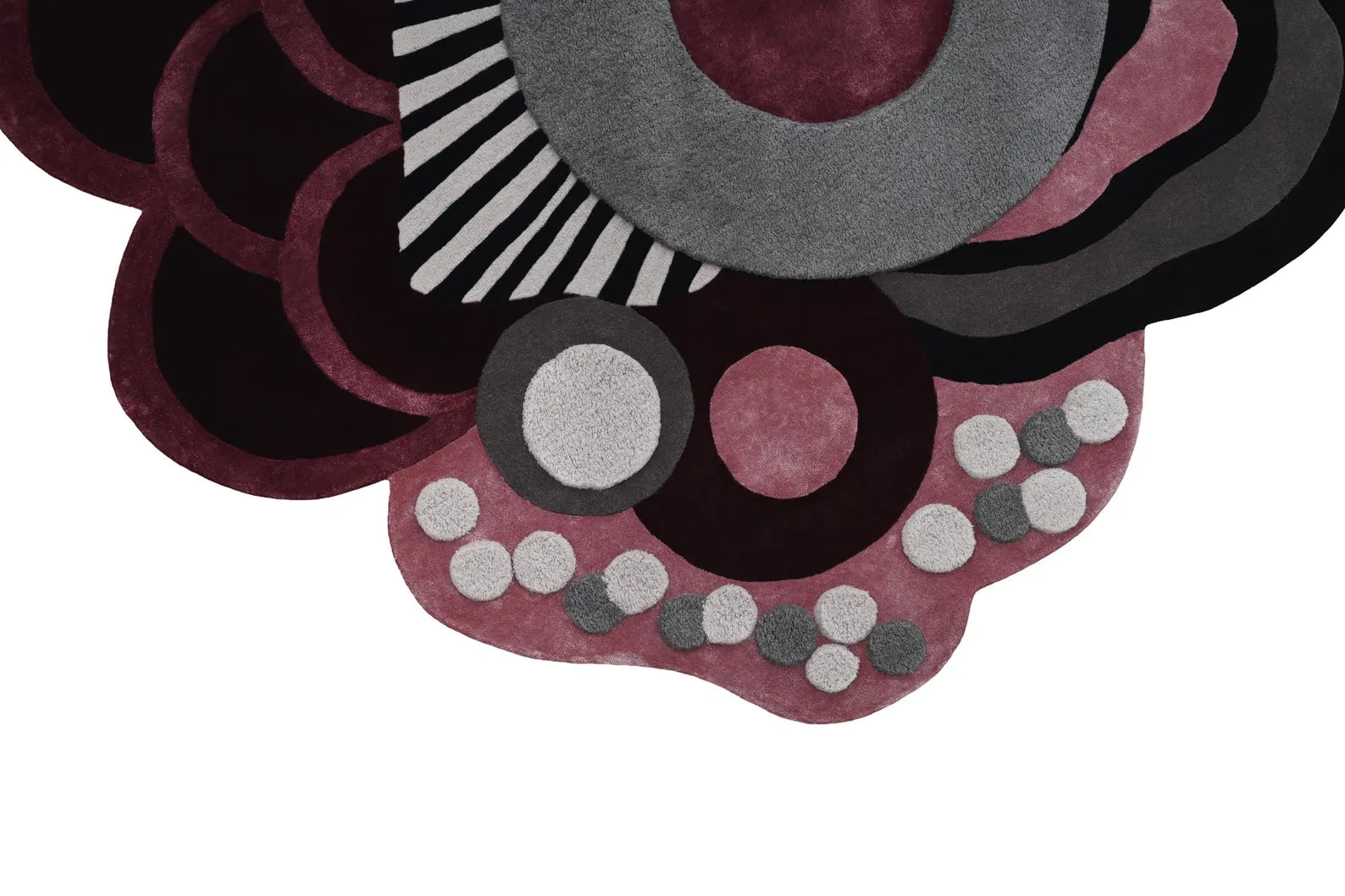 Side view of Chic Abstract Floral Rug highlighting sculptural, irregular edges.

Folded view of Chic Abstract Floral Rug showing hand tufted texture and wool finish