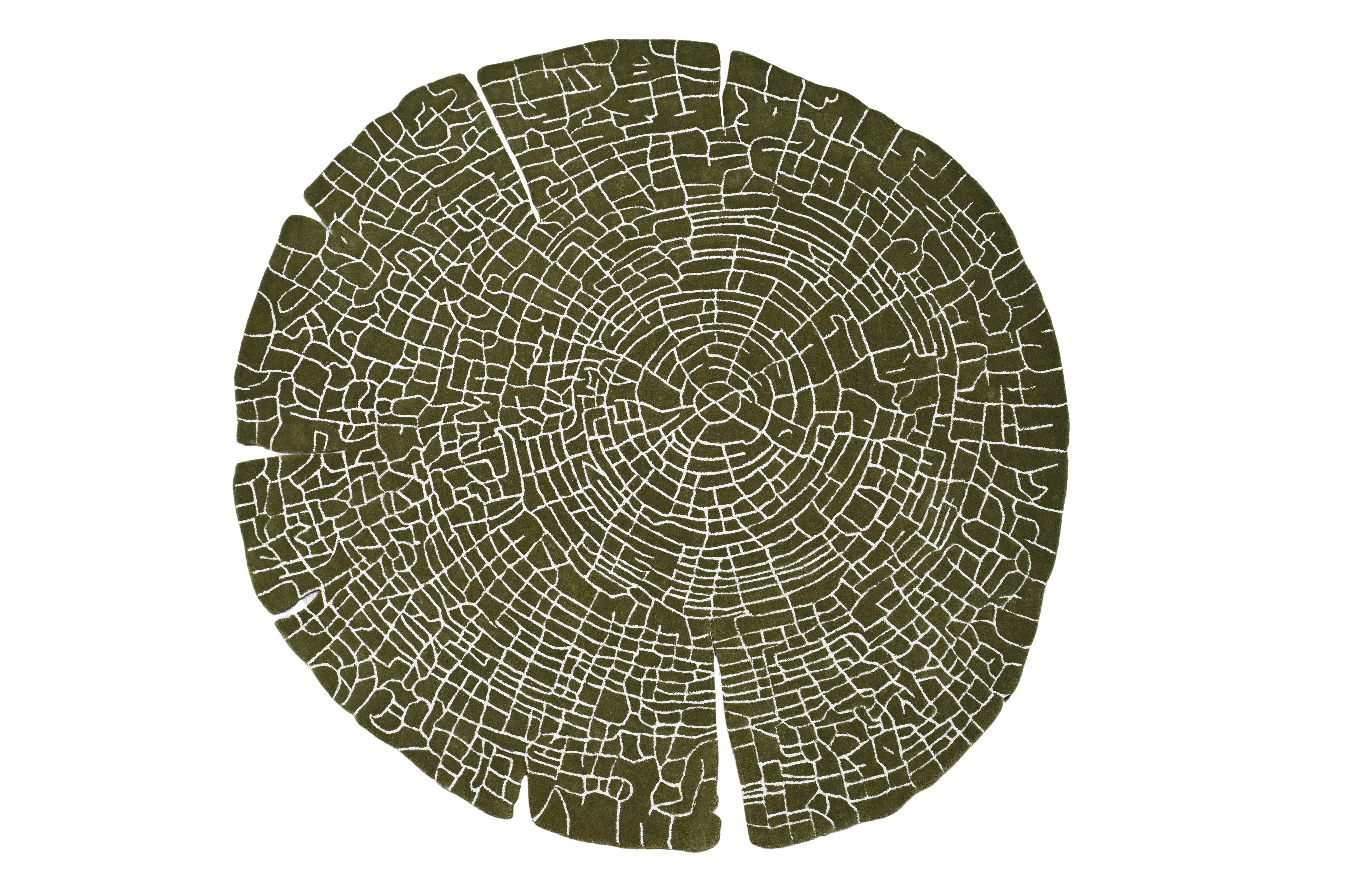 Round rug with intricate wood-inspired pattern in olive tones.