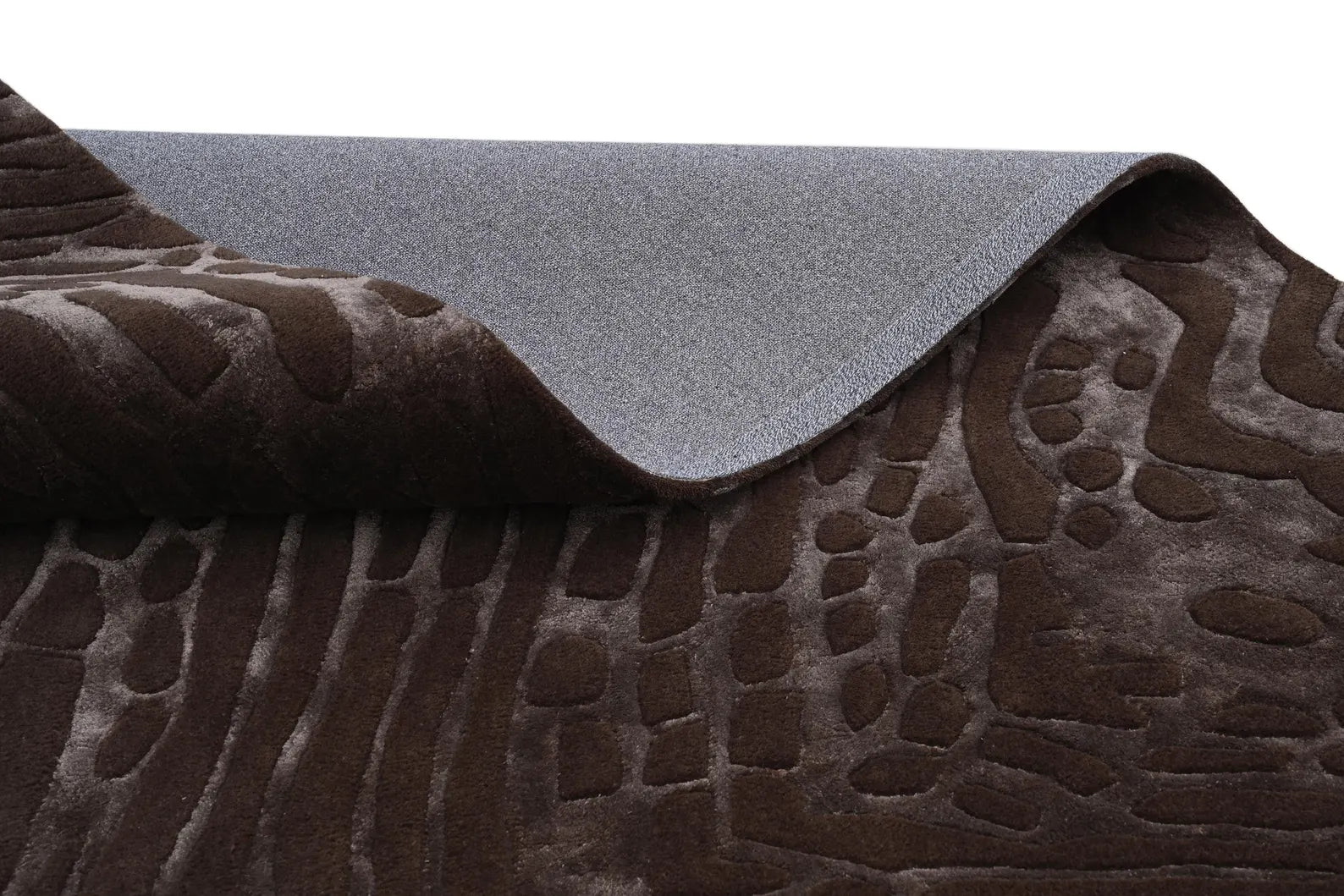 Detailed look at carved fossil-inspired patterns in deep brown tones.