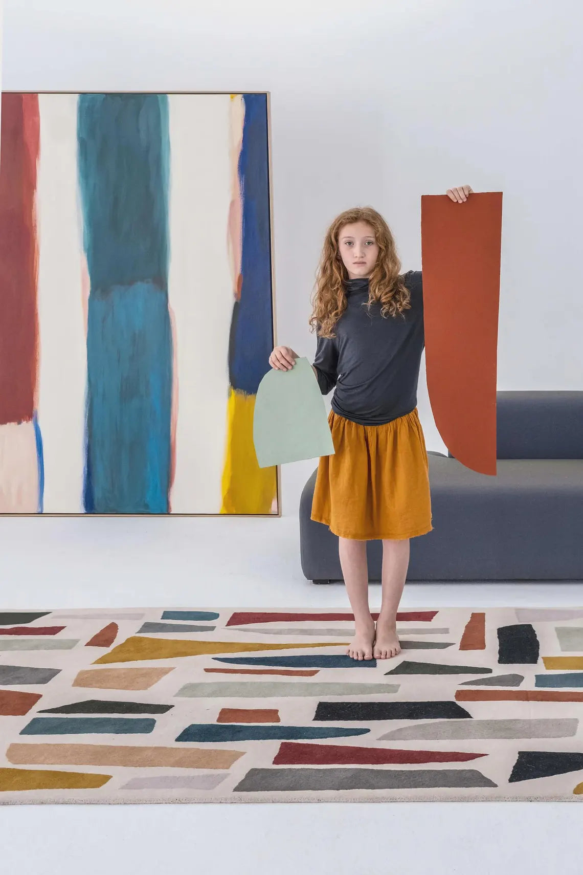 Rug placed in a modern interior with abstract wall art, showcasing its artistic design.