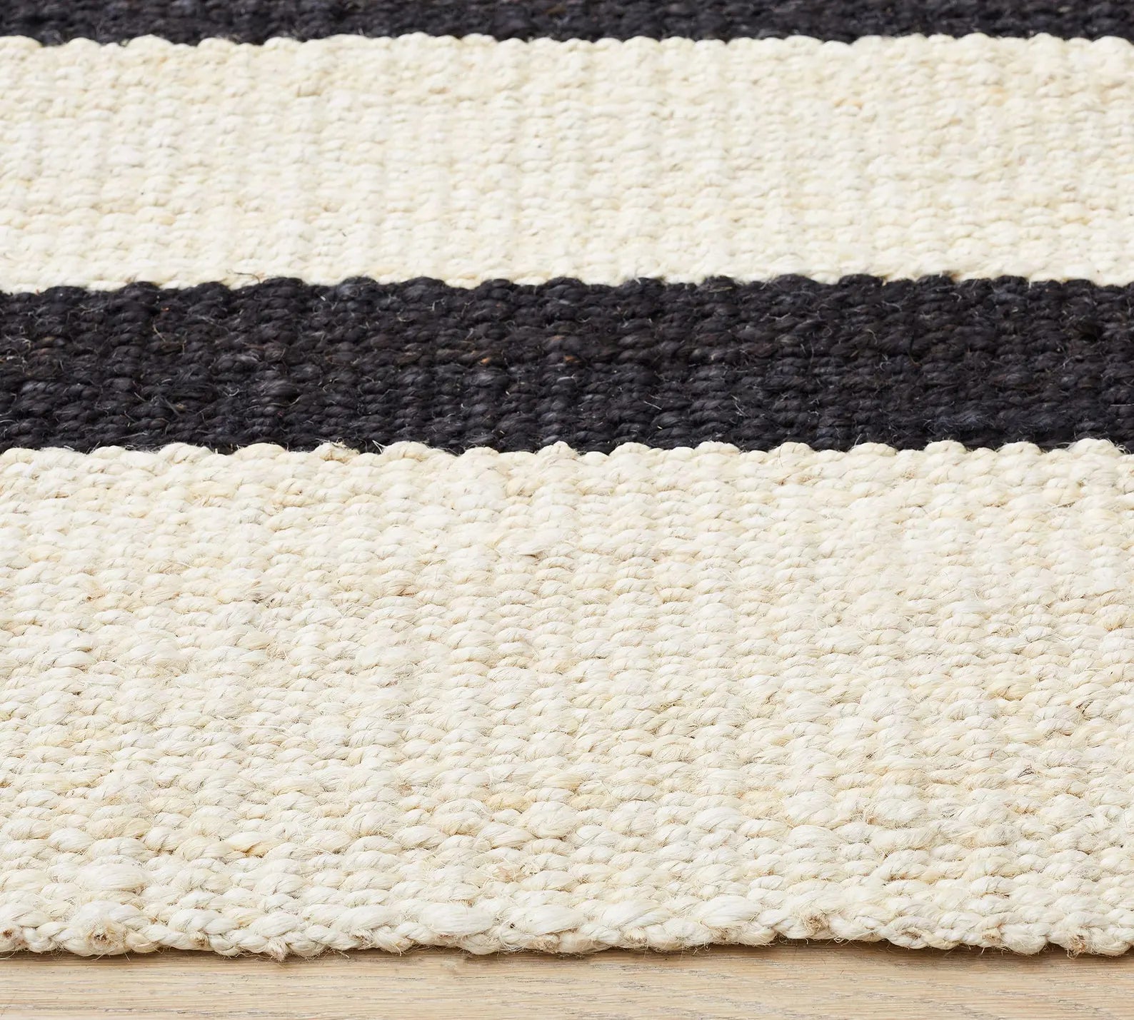 Loomtrail Rug variant featuring bold black stripes on ivory background with textured handwoven appeal.