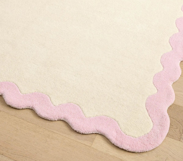 Corner detail of Lullaby Rug highlighting curved scallop edge and smooth hand tufted finish
