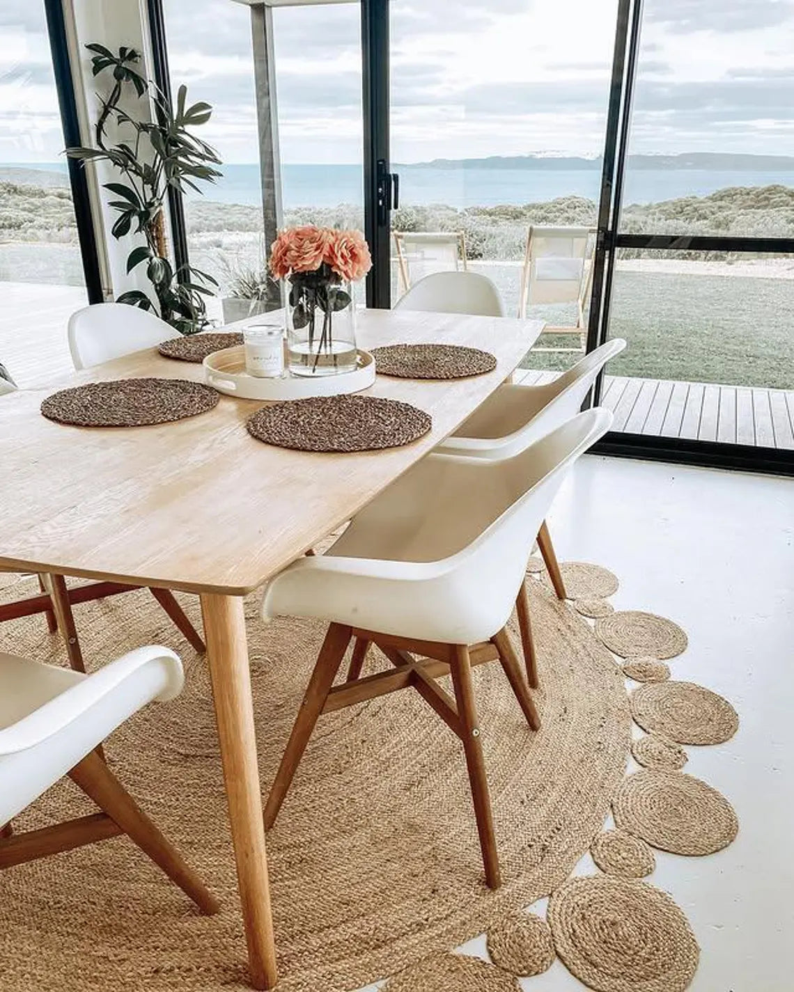 Jute rug styled with simple dining arrangement.