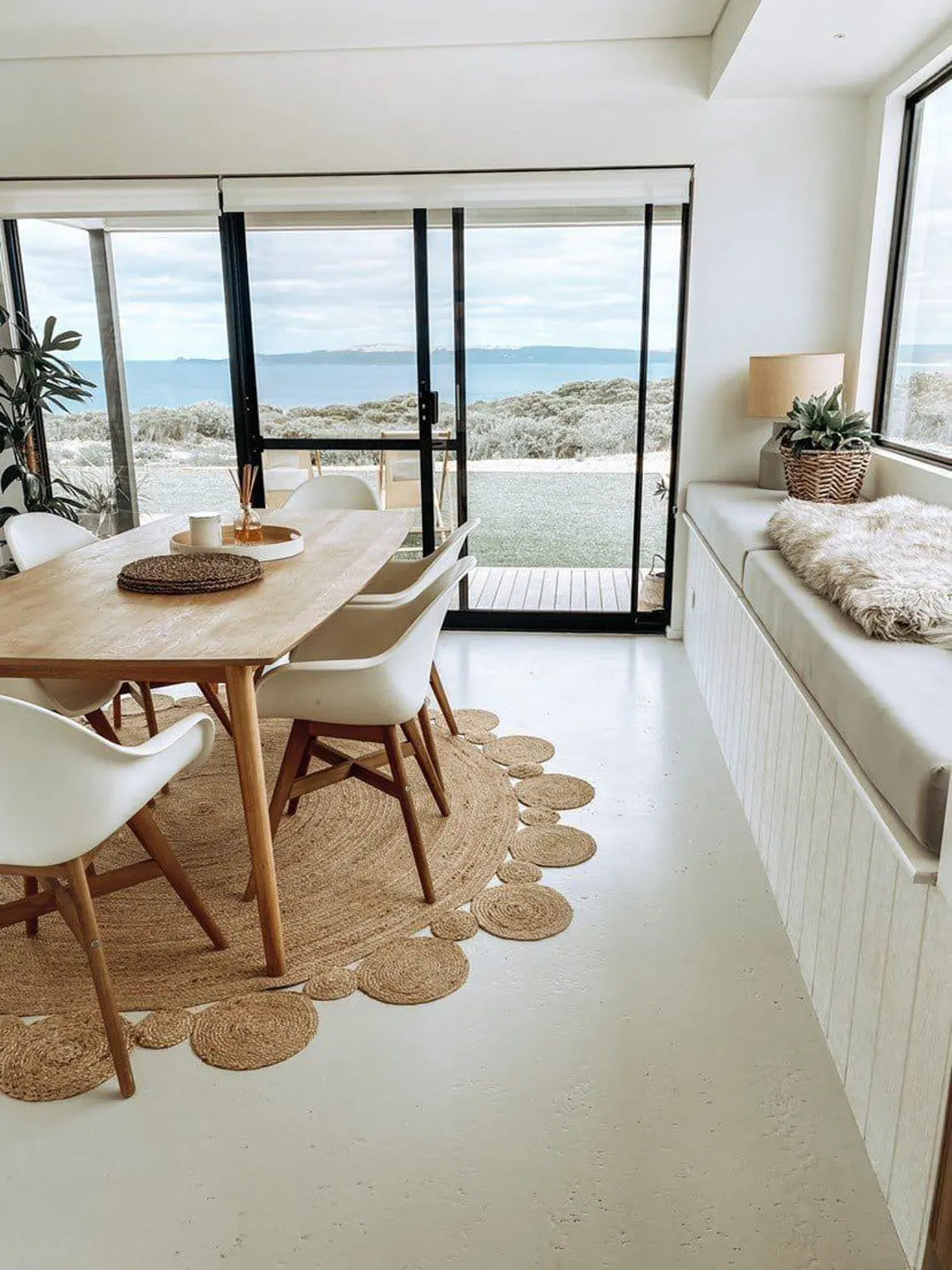 Jute rug styled with simple dining arrangement.