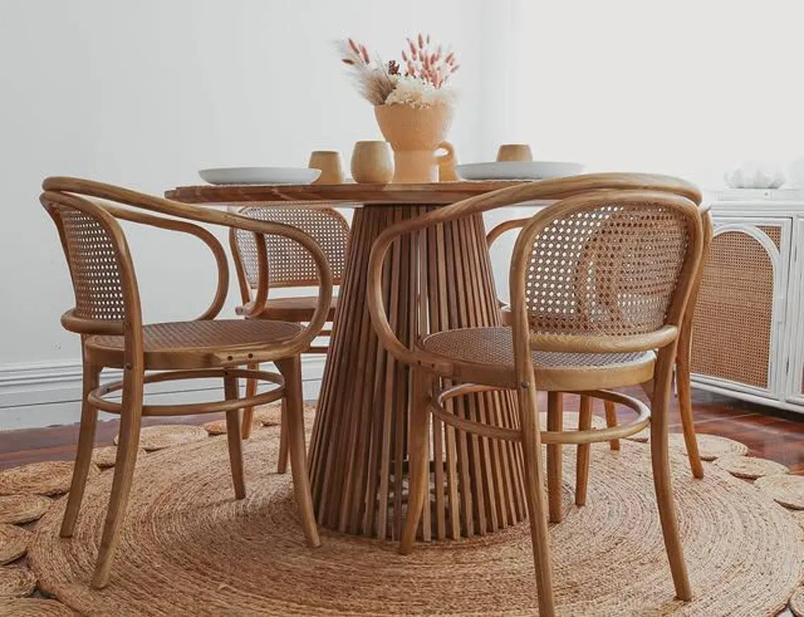 Rustic jute rug paired with wood dinning furniture.