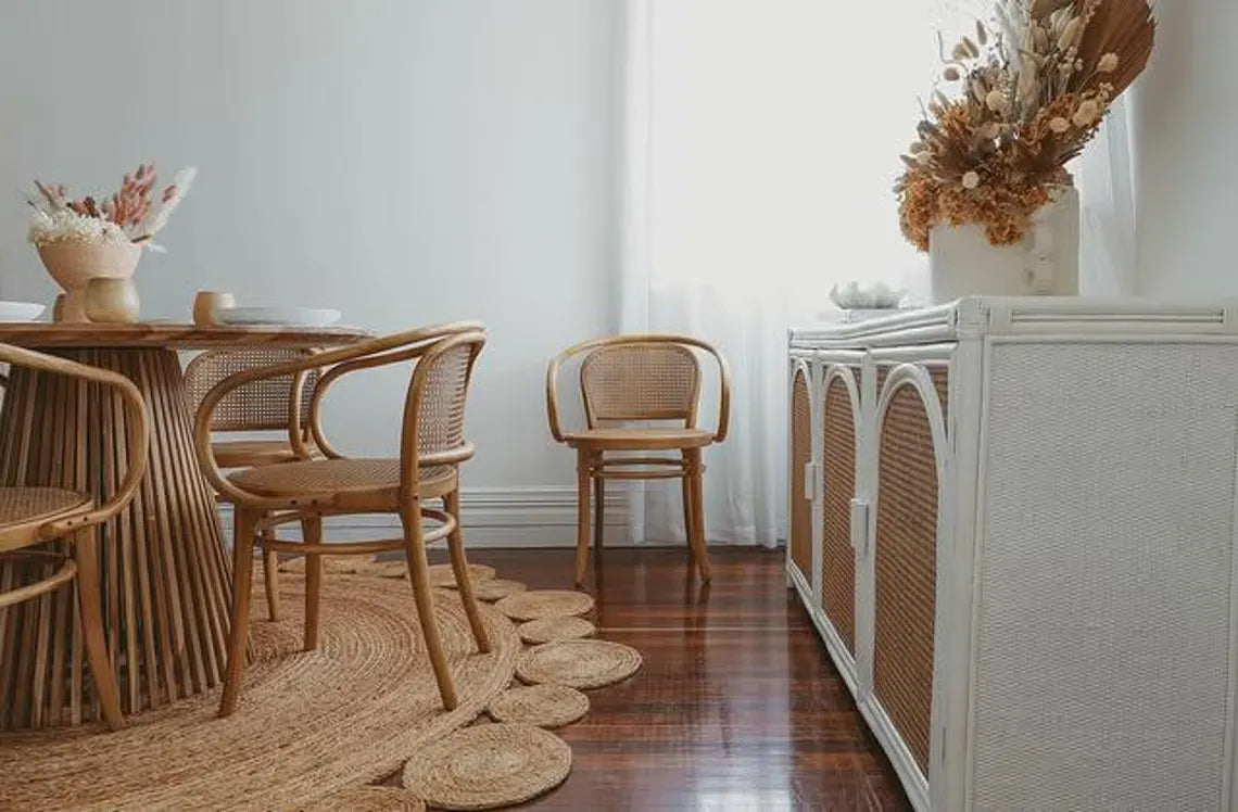 Rustic jute rug paired with cane and wood furniture.