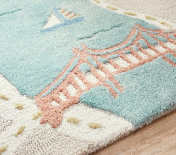 Detailed section of MiniCity Rug highlighting textured bridges, soft wool surface, and pastel-colored buildings.