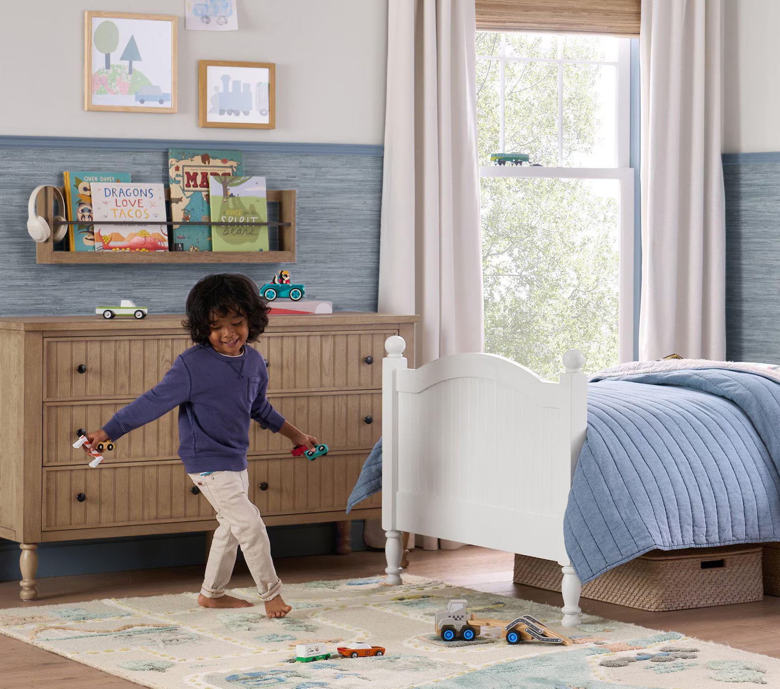 MiniCity Rug displayed in a cozy kids’ bedroom as a child plays with toy cars, surrounded by a wooden dresser, bed, and bookshelves.