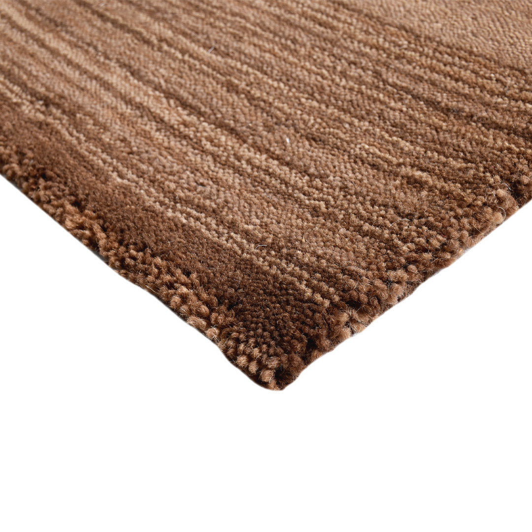 Close-up corner detail of the handloom Mocha Stripe Textured Wool Doormat showing its textured wool weave and brown striped pattern.