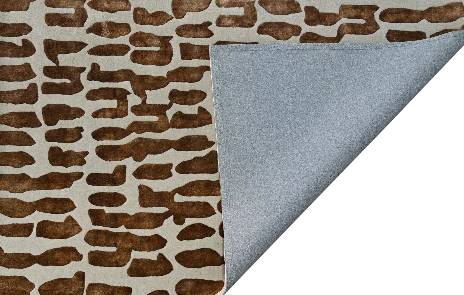Corner fold view of Modern Tribal Rug showing underside backing and smooth finishing of hand-tufted surface