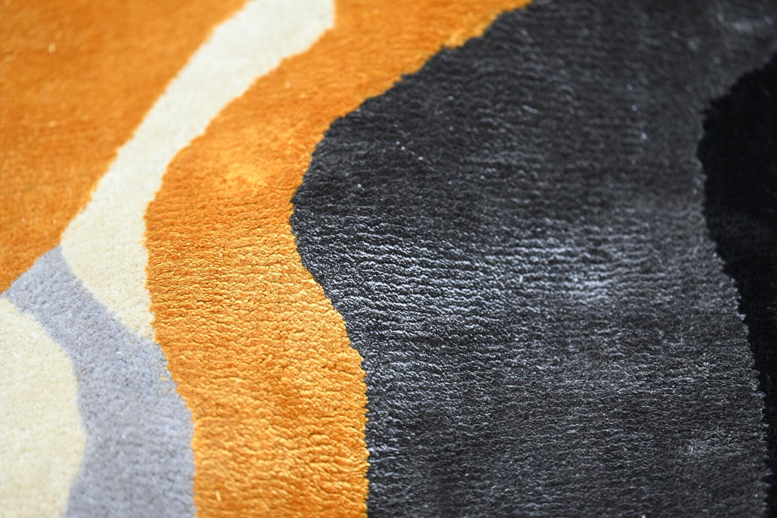 Close shot of rug fibers, showing the softness and rich hand tufted craftsmanship.