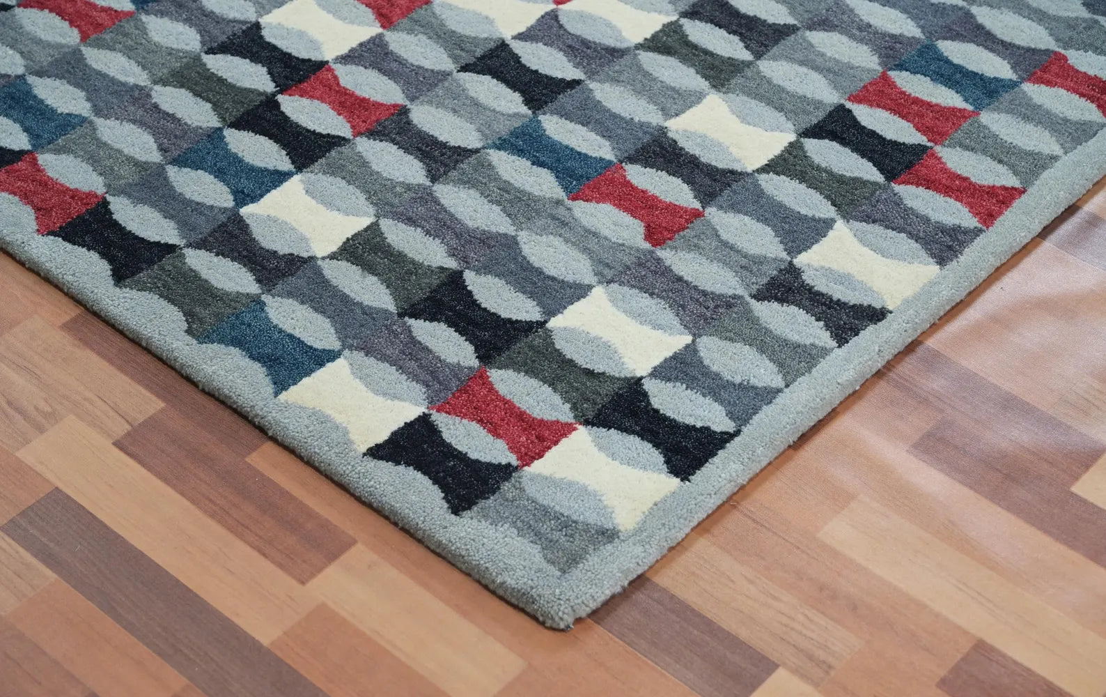 Monotone Matrix Rug placed beside modern furniture and plants highlighting its bold geometric blocks and soft wool texture.