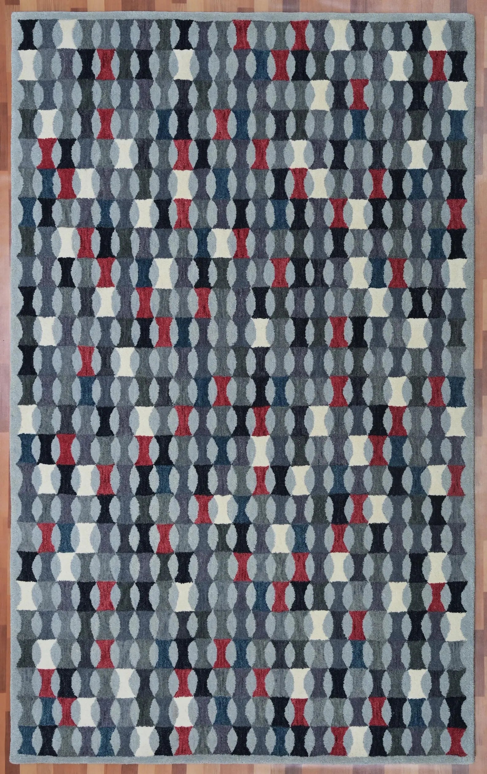Monotone Matrix hand tufted rug displayed flat from top angle showing complete pattern layout with balanced tones of grey, white, and crimson red.