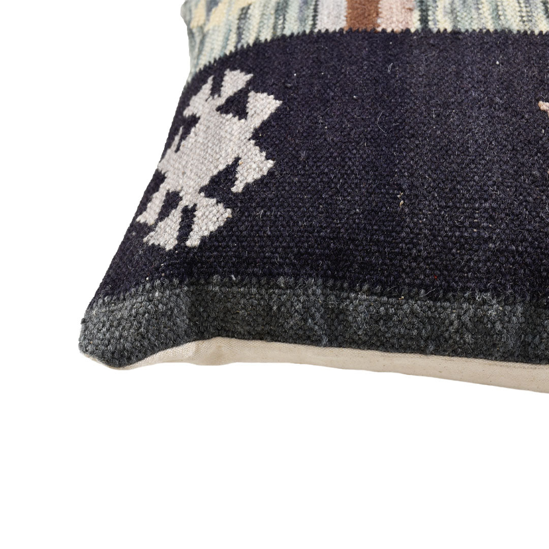 Close-up corner detail of the Nordic Tribal flatweave wool pillow showing the weave and tribal pattern.