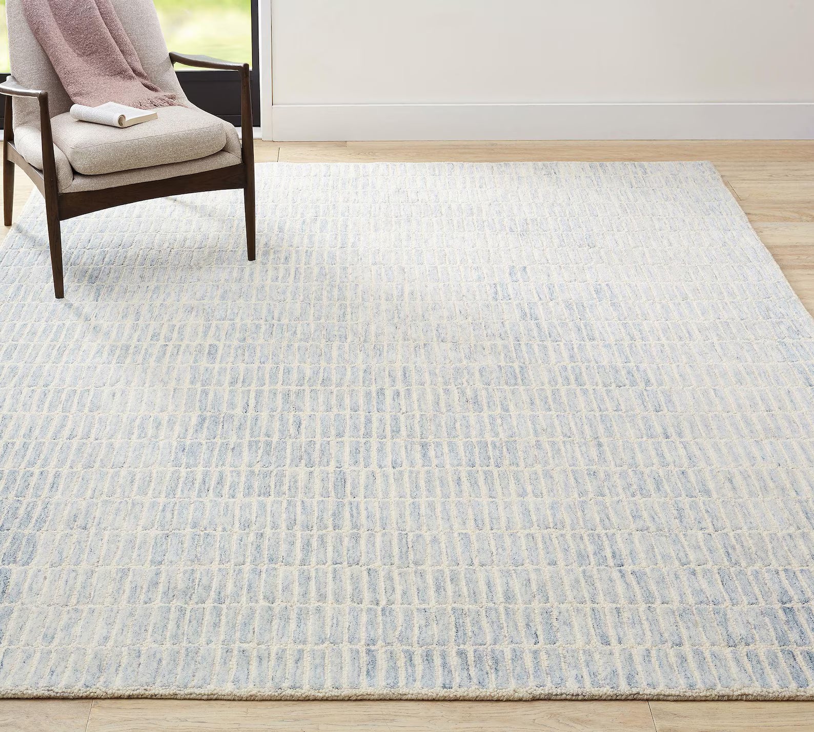 Ocean Breeze Rug styled in a modern living room with chair.