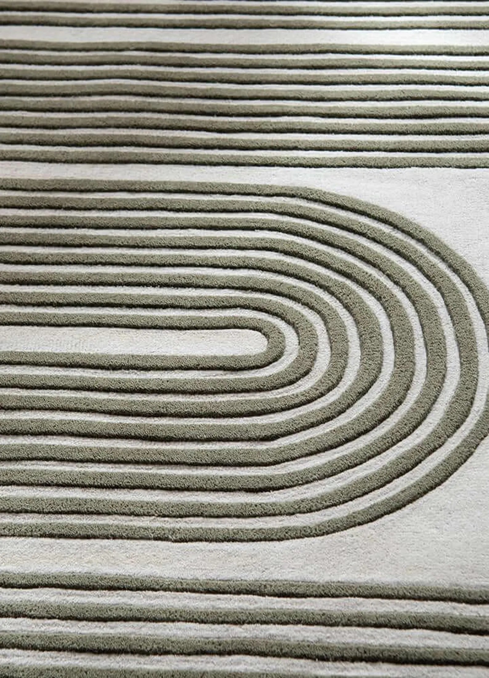 Detailed close-up of Olive Maze Rug showing its soft wool texture and curved tufted pattern in sage green tones.