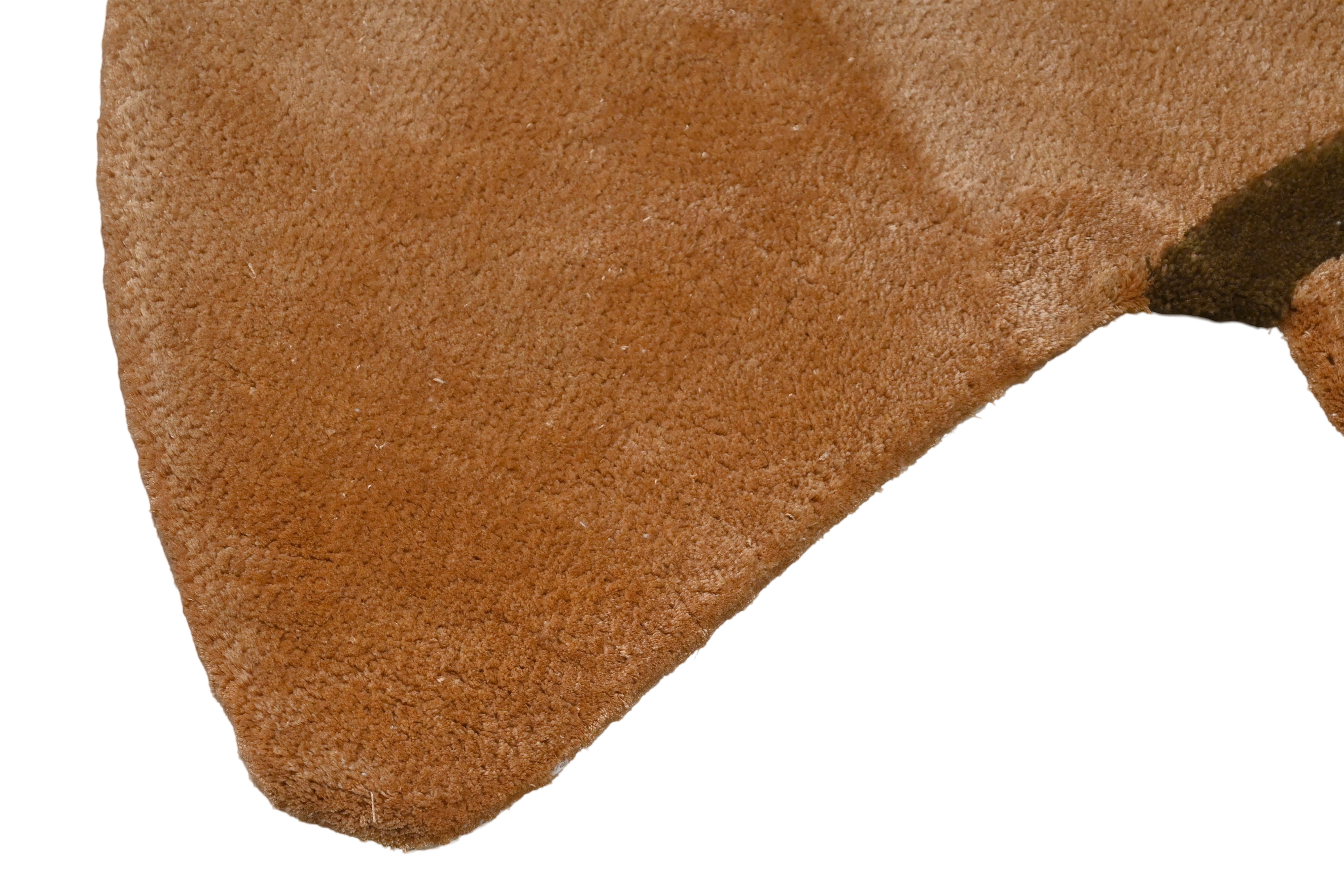 Close-up of the rug edge in warm earthy brown tones.