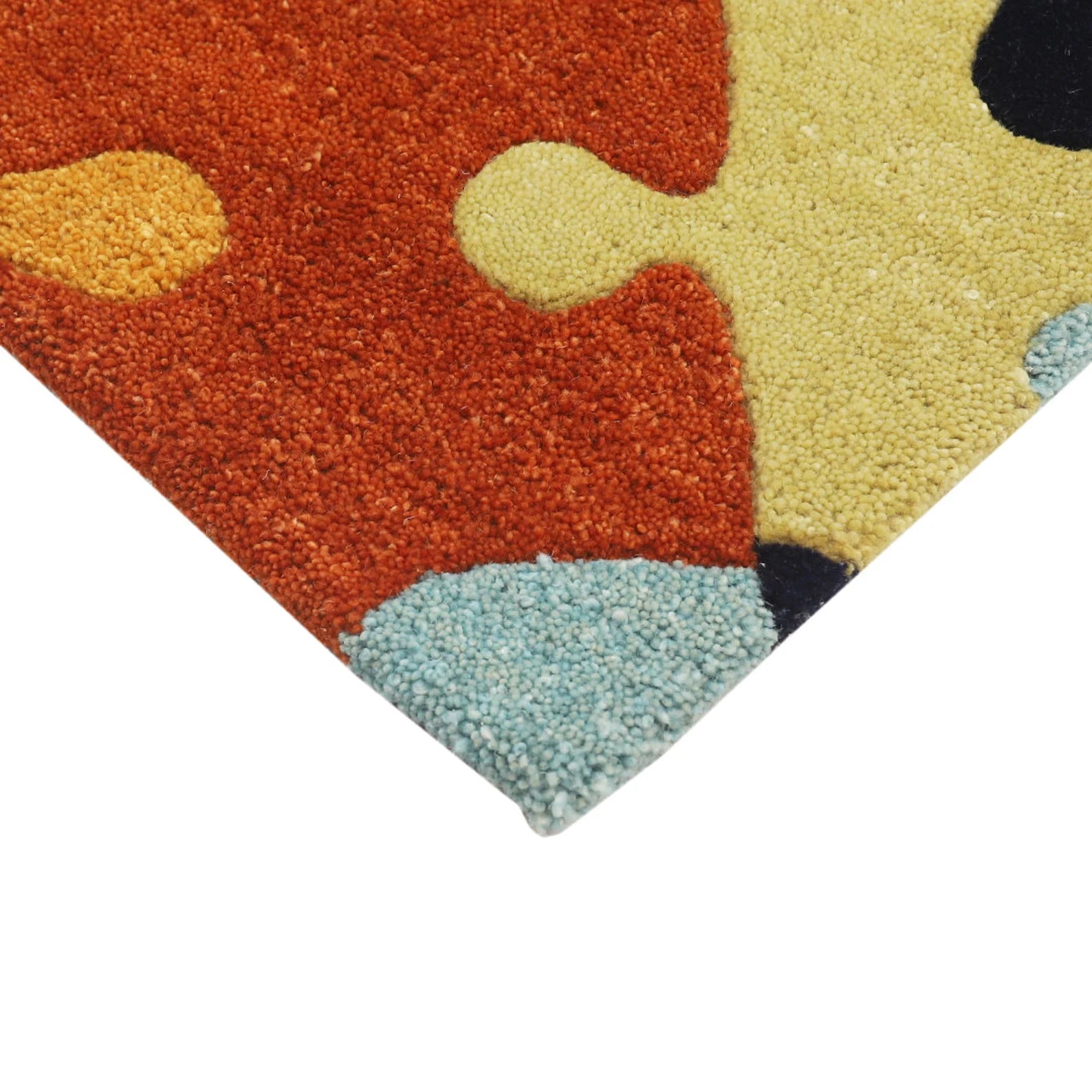 Corner detail of Playgrid Rug showing seamless finishing and colorful puzzle motifs.
