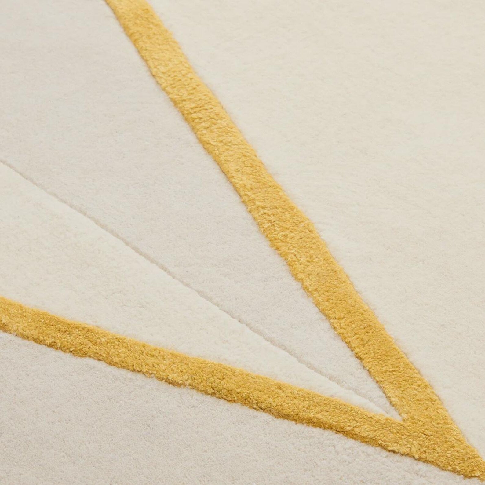 Rayform Rug close texture view showing soft ivory pile and fine golden line detailing with smooth hand tufted surface