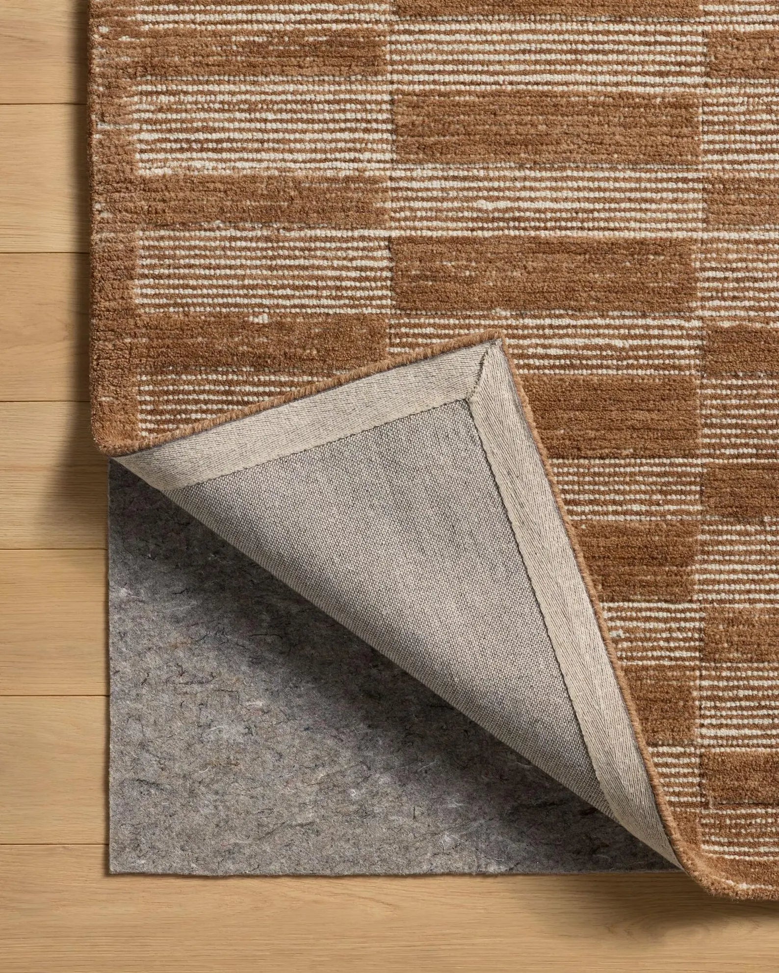 Folded edge of Rustic Checkered Rug displaying quality finishing.
