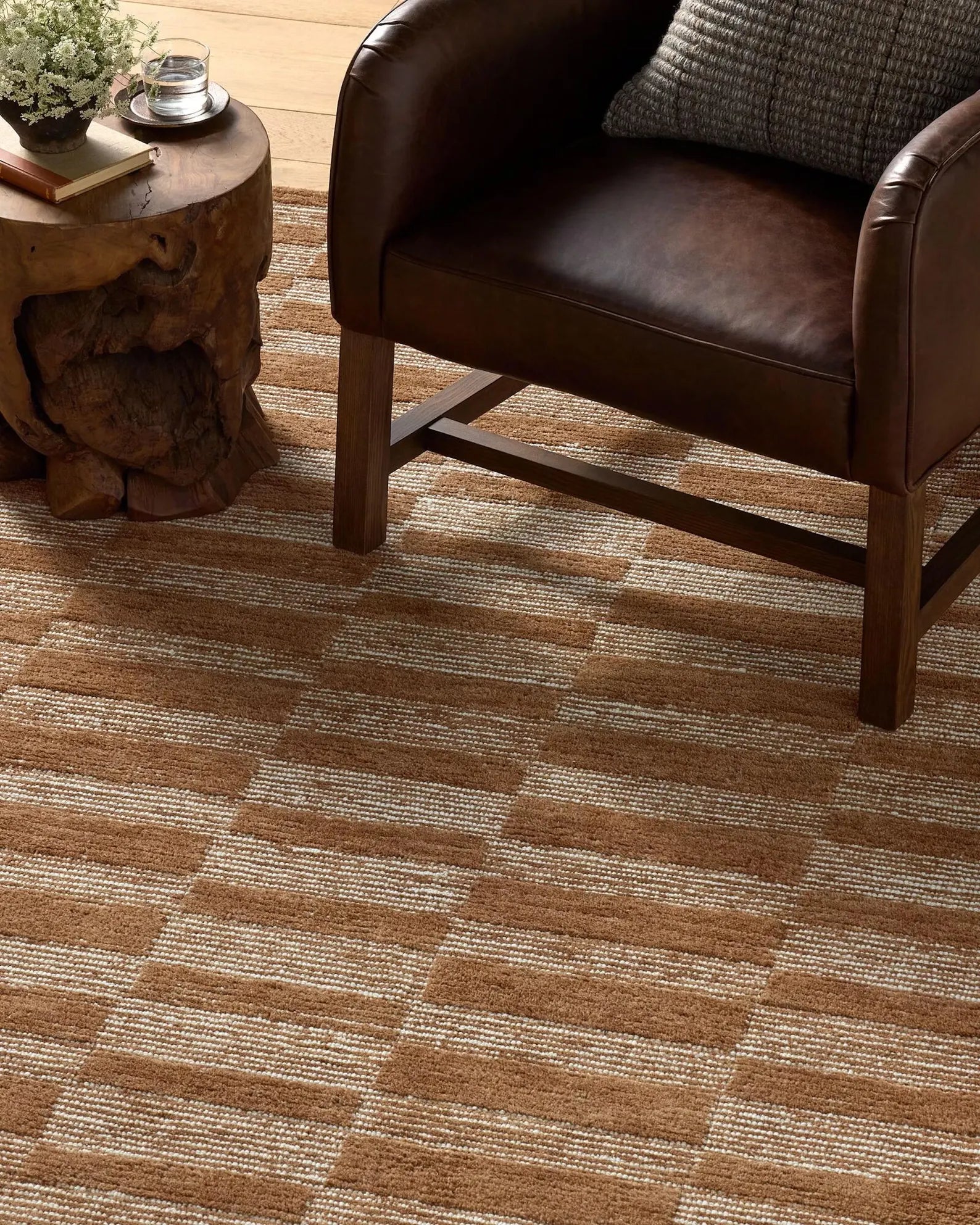 Rustic Checkered Rug styled in a cozy living room with wooden furniture.
