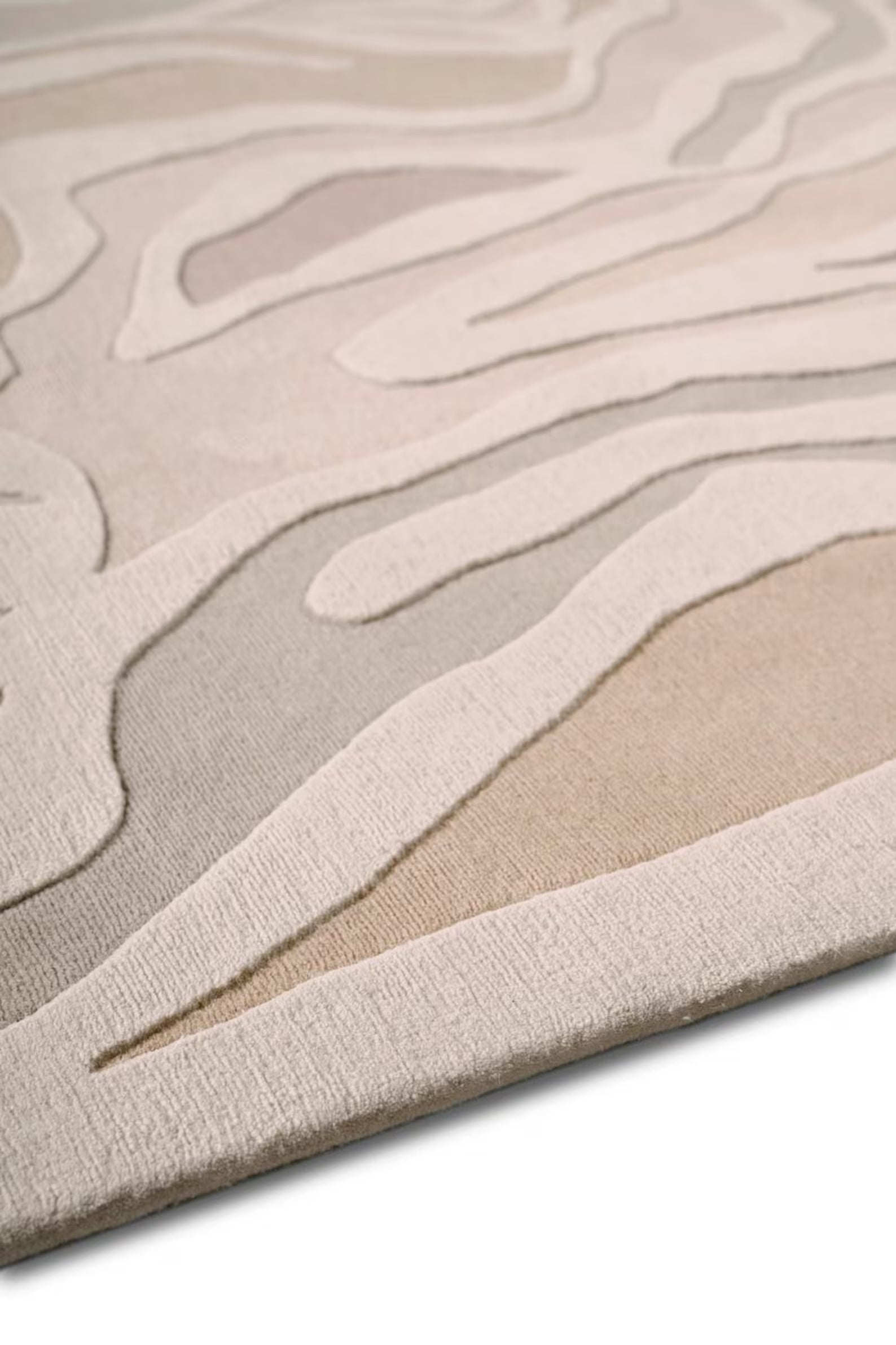 Sandstone Swirl wool rug photographed from side angle highlighting raised pattern – Decordec
