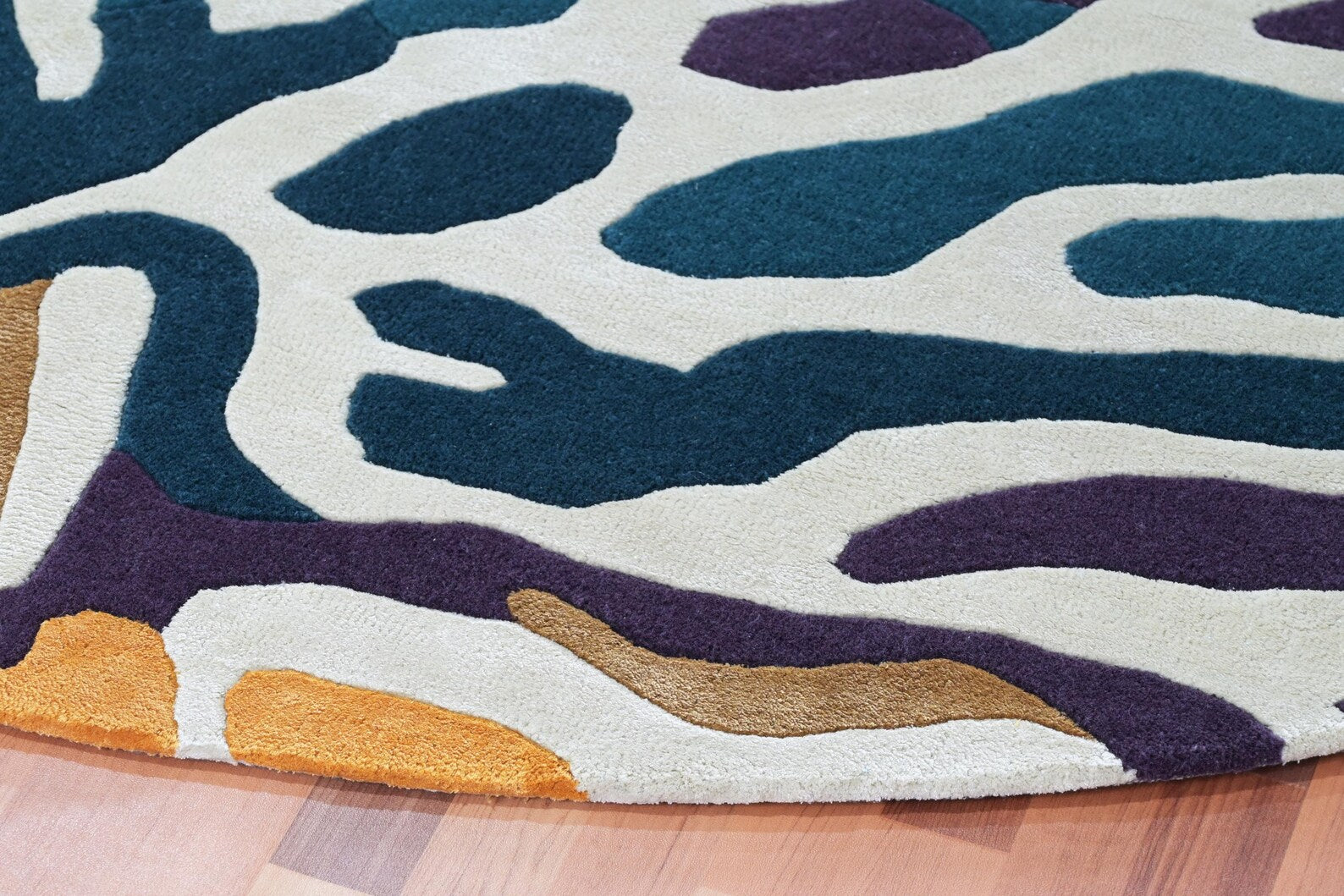 Seaform Rug pattern view highlighting ocean plant inspired design with fluid shapes in deep blue, teal, ivory, and gold tones