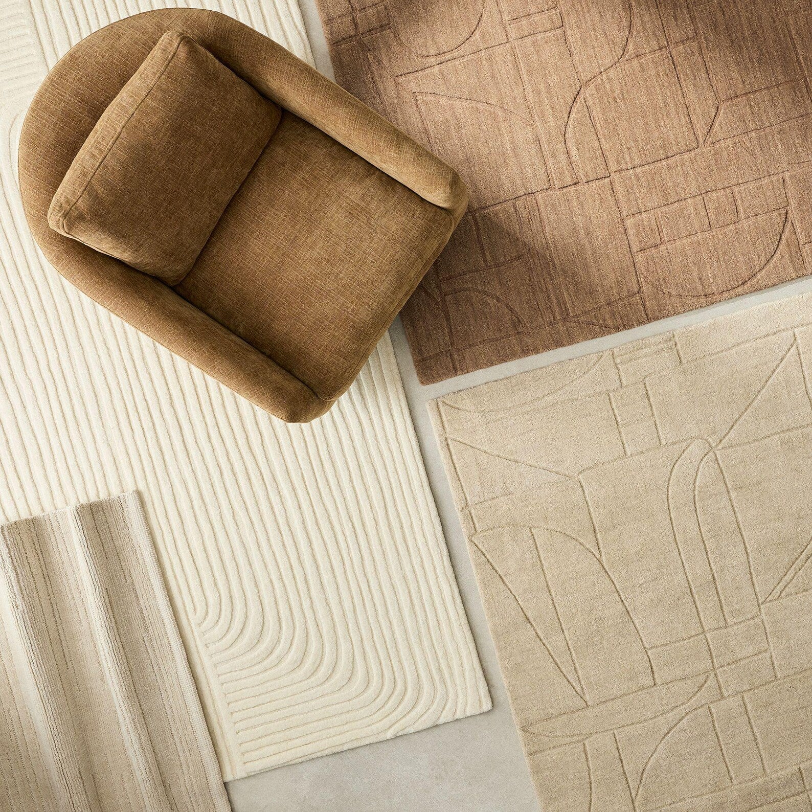 Softwave Rug styled with neutral home décor pieces, showing smooth wave pattern and soft off-white tone on hardwood floor.