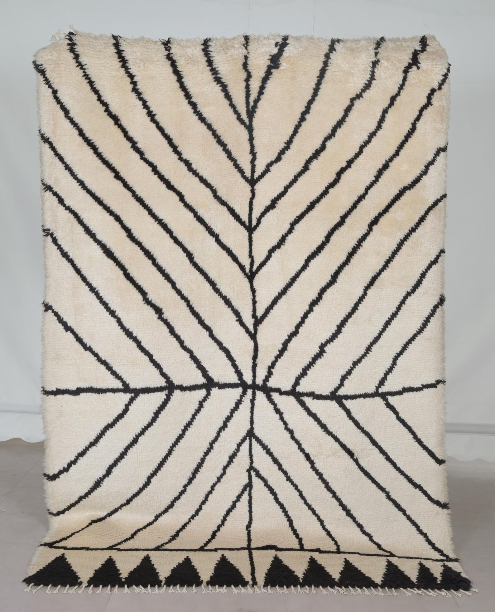 Stemline Moroccan_hand_knotted Rug full view showing bold black linear leaf pattern on a soft ivory base.